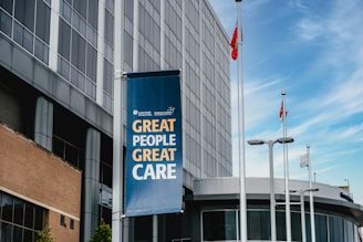 Modern building with a banner reading "great people great care"