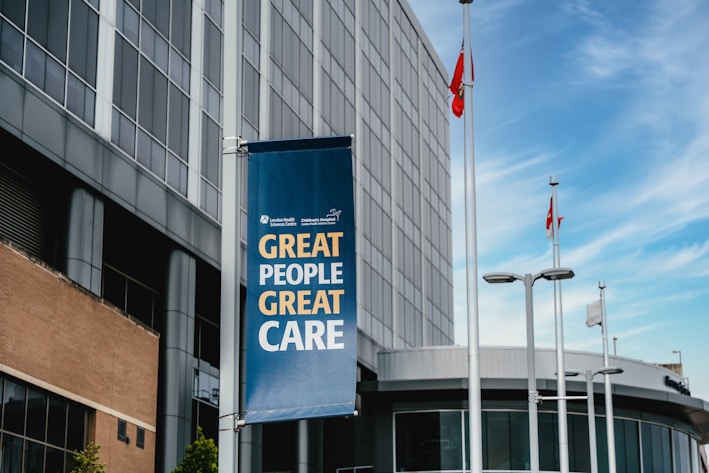 Modern building with a banner reading "great people great care"