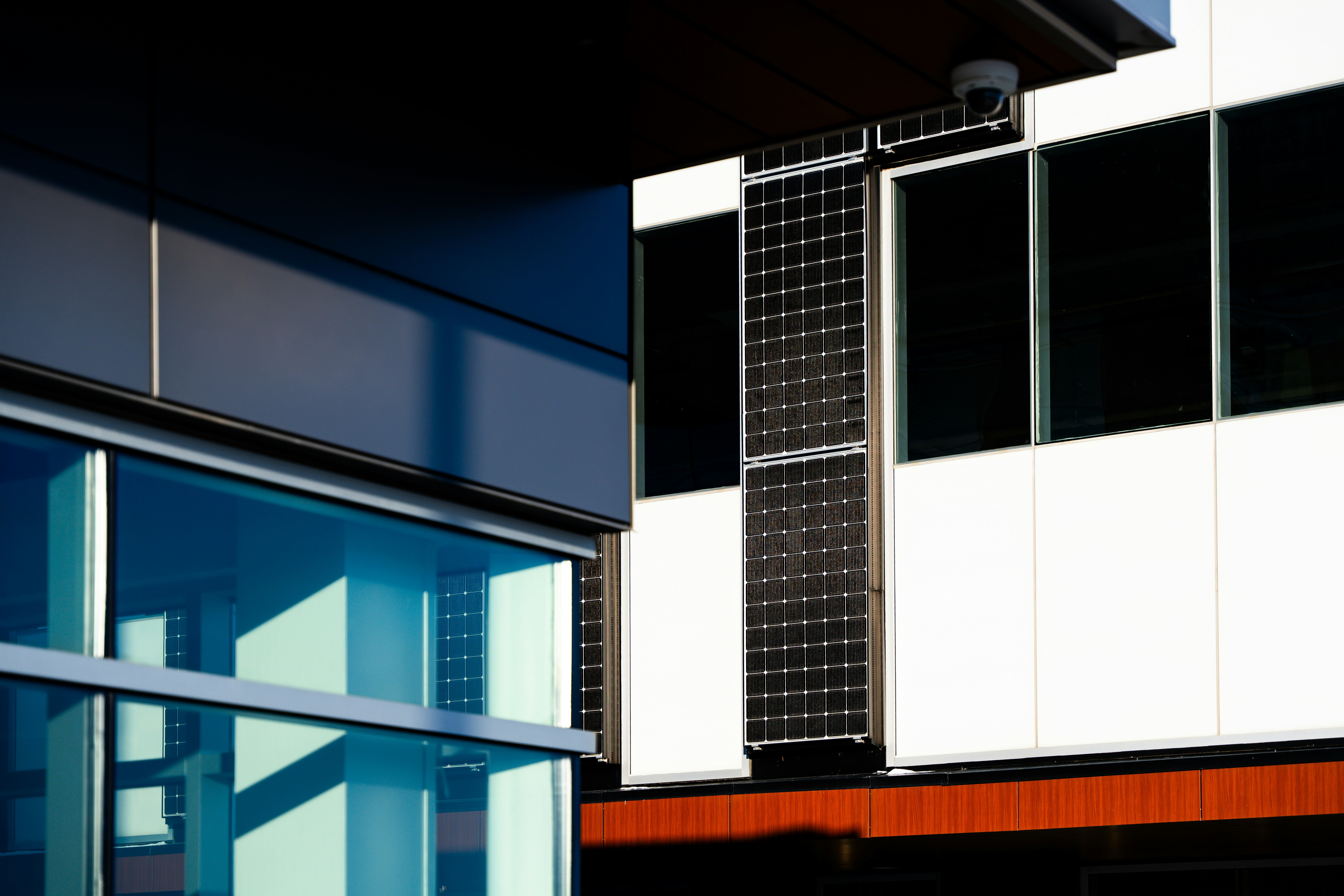 modern commercial building with green spaces and solar panels, symbolizing sustainable development - Site selection solutions