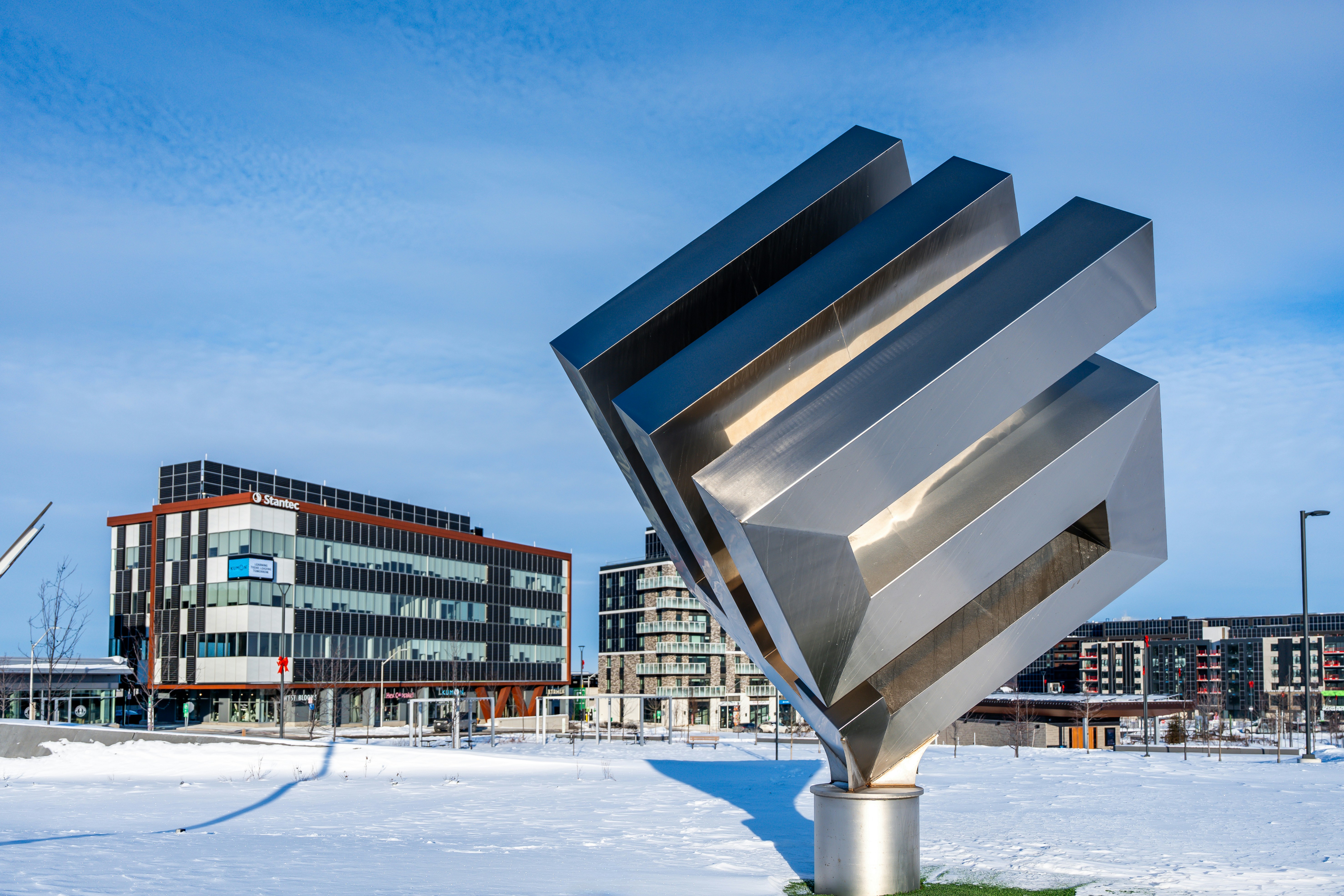 Modern sculpture in a snowy urban park