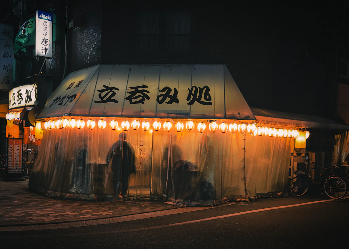 Illuminated restaurant signs in a Tokyo alley at night