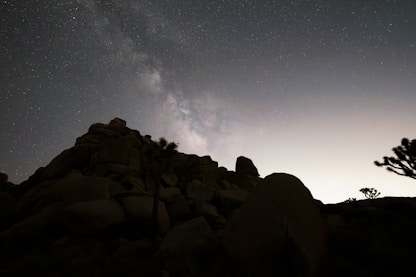 Milky way over rocky desert landscape at night