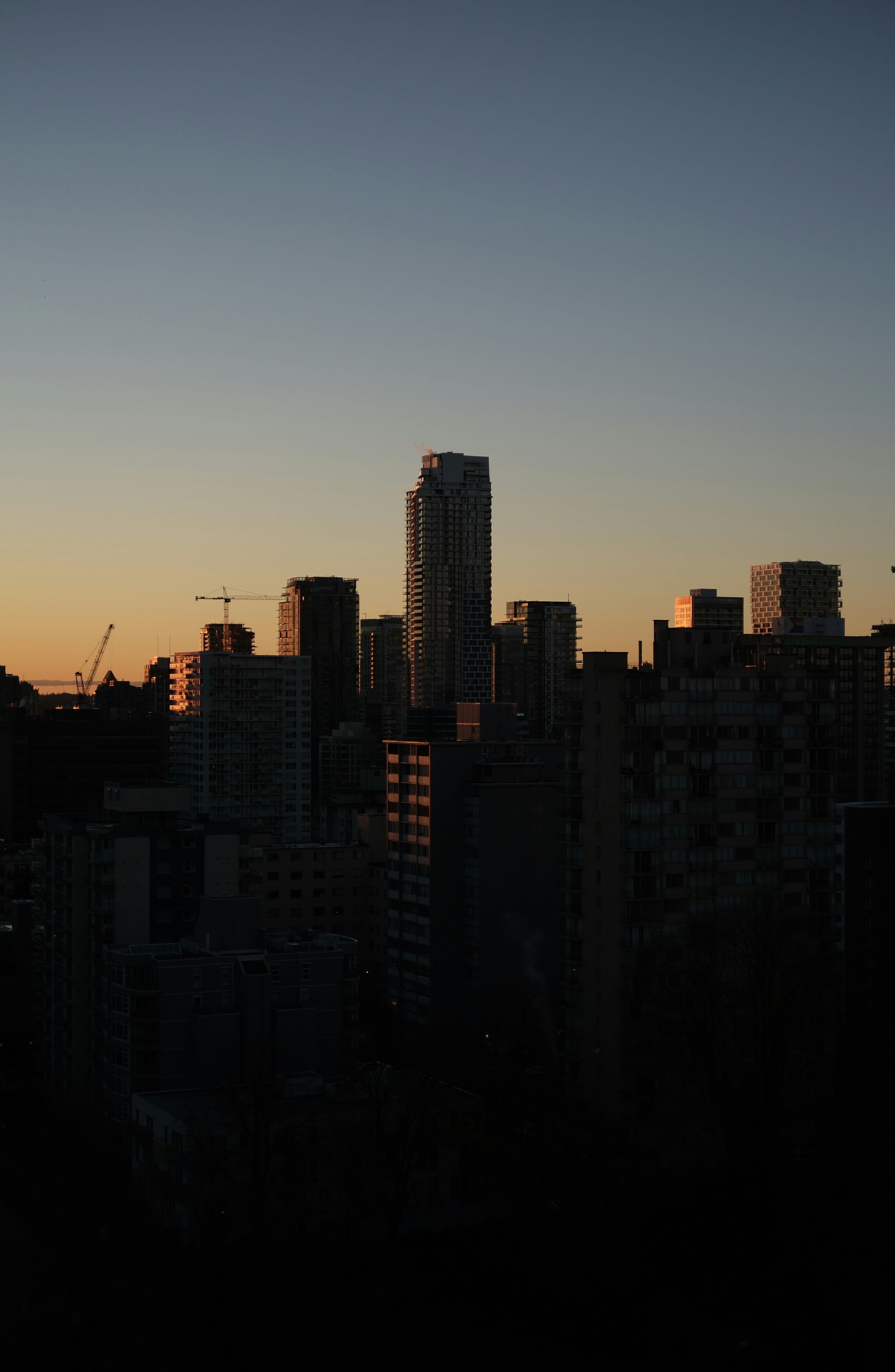 City skyline at sunset with tall buildings