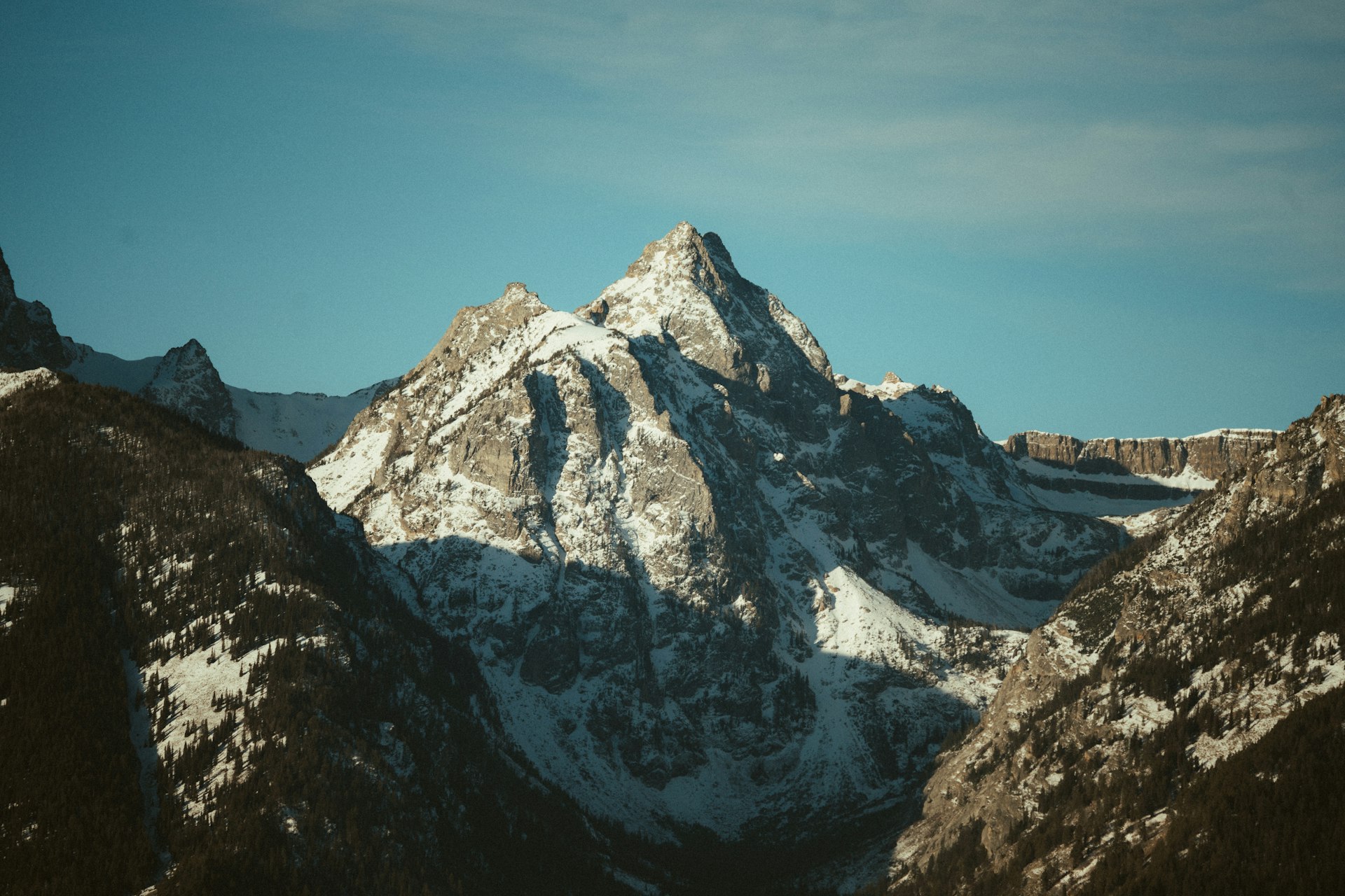 Snow-covered mountain peak under a clear blue sky