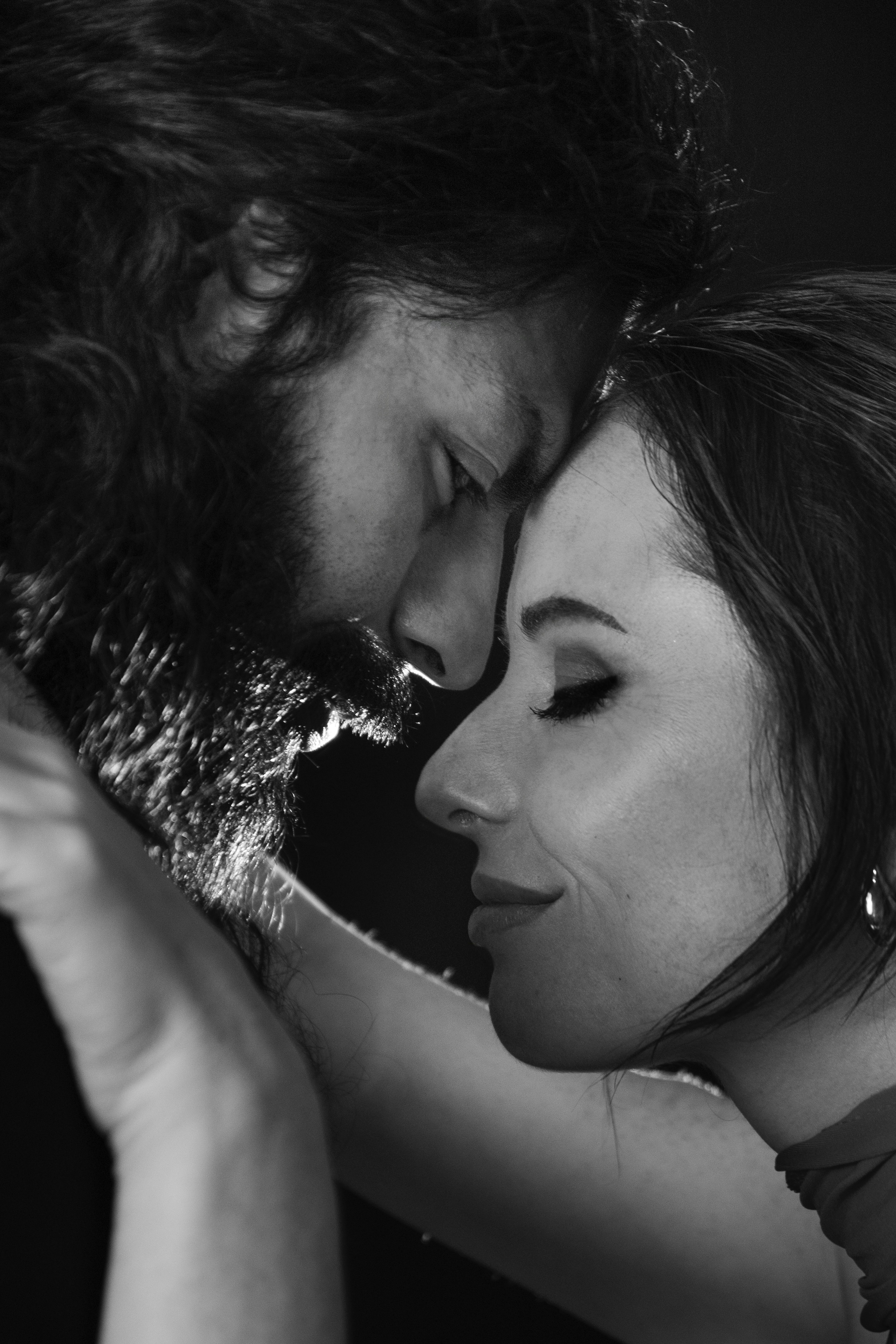 Couple embracing intimately in black and white.