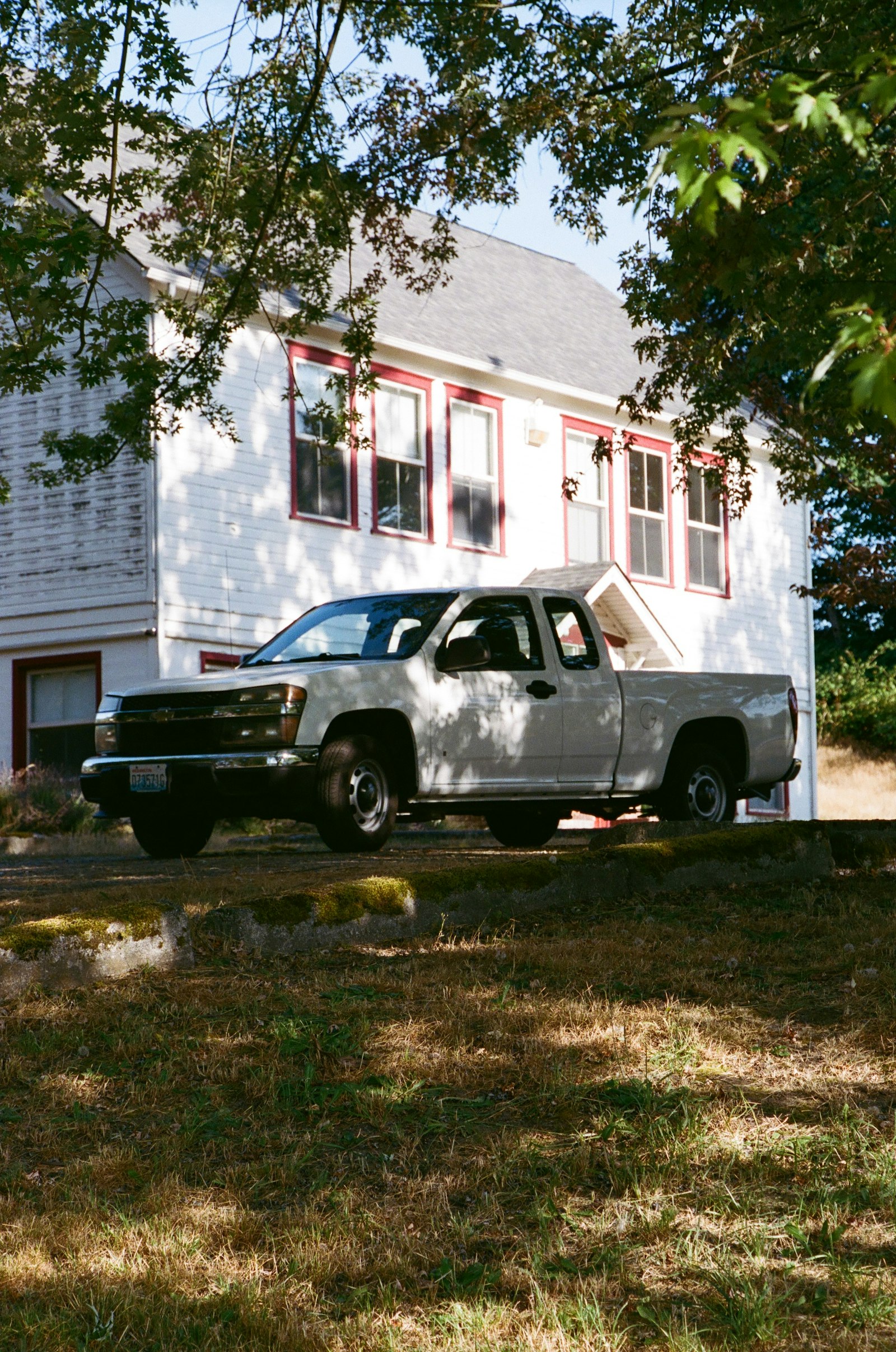 A pickup parked at a house on a small town street