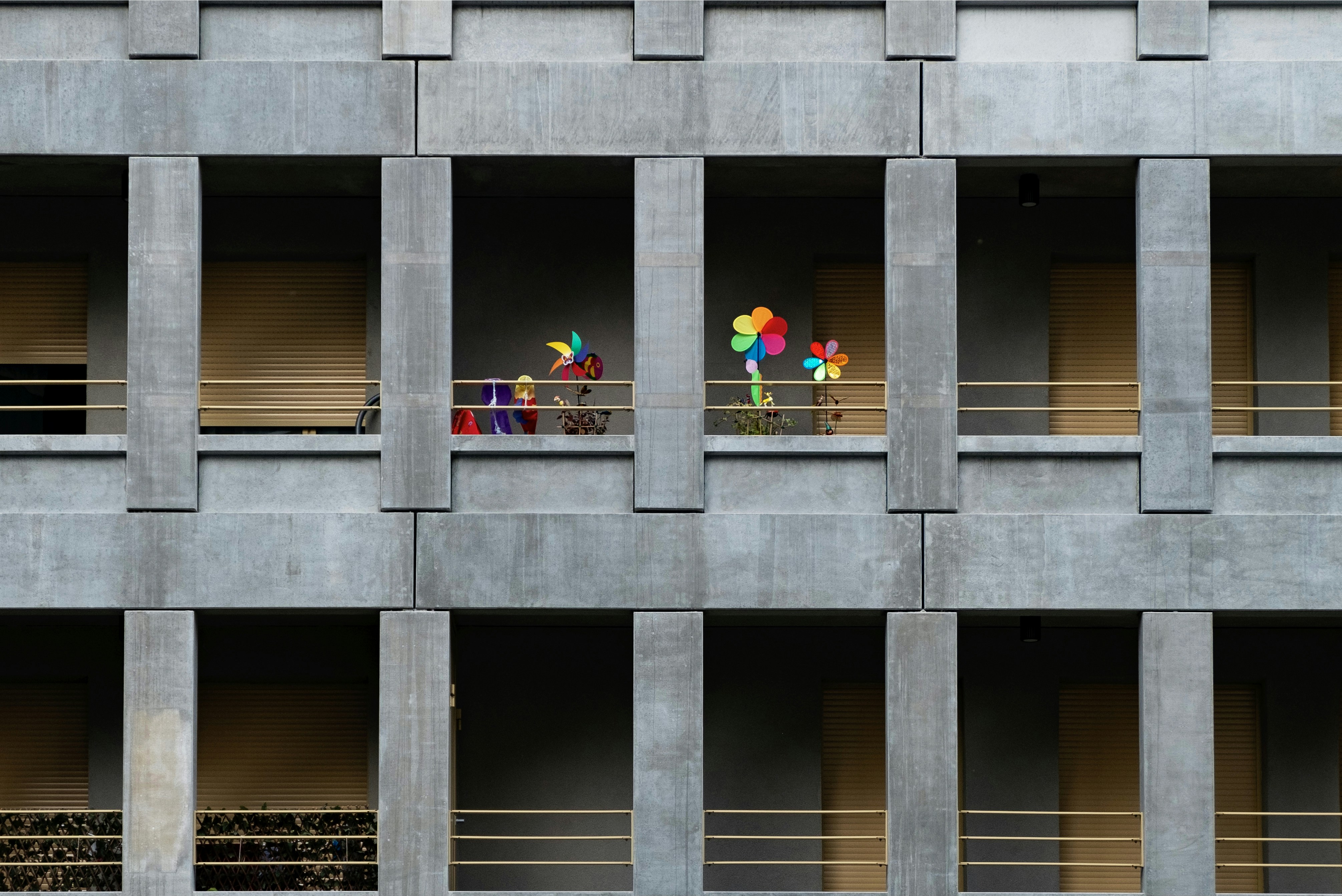 Colorful pinwheels on a modern building balcony