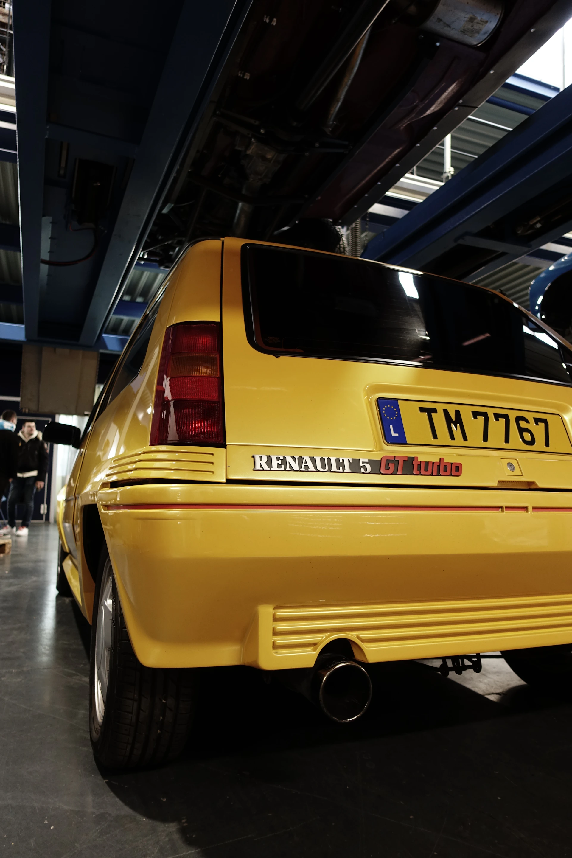 Rear view of a yellow renault 5 gt turbo car.