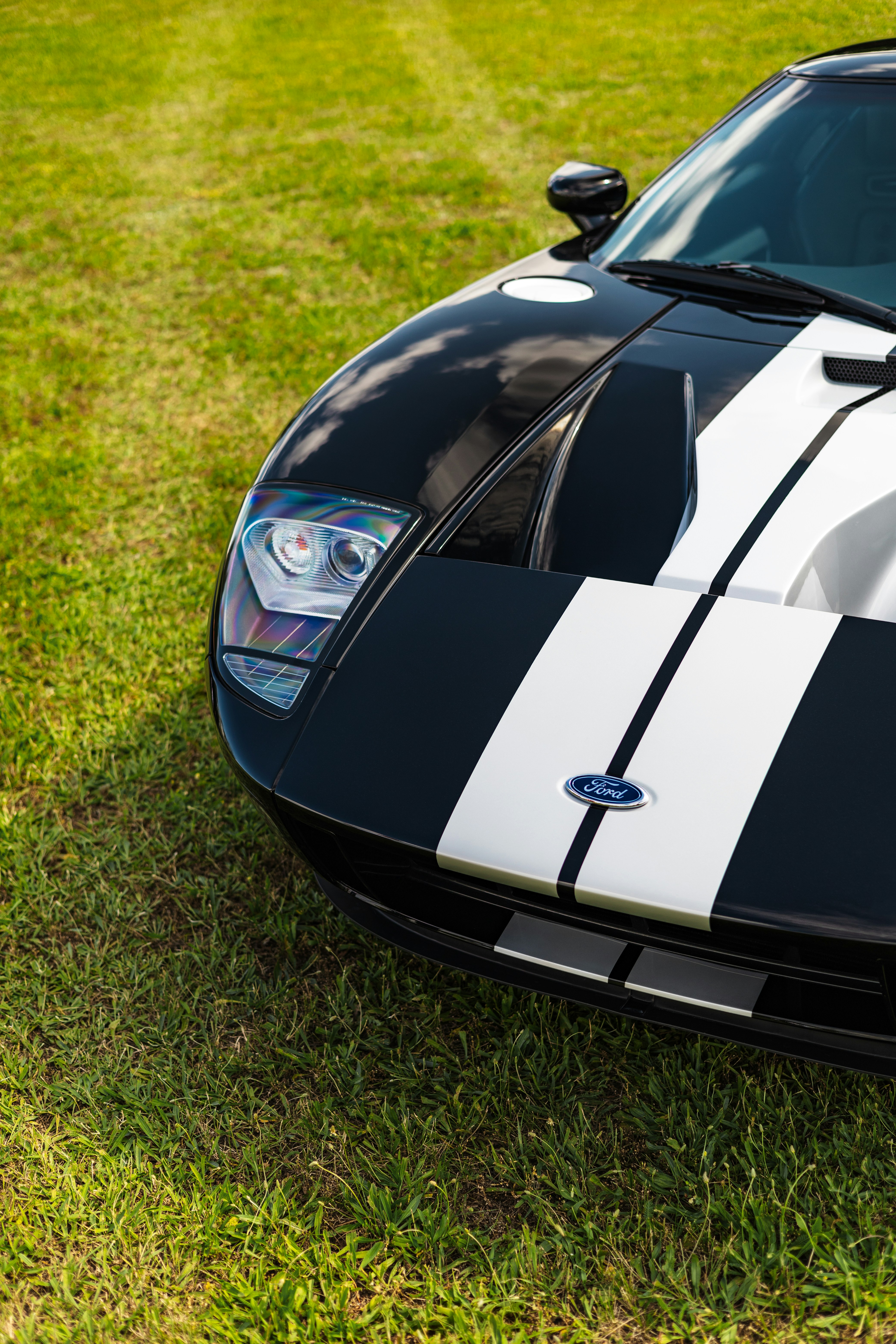 Black and white striped ford car on grass