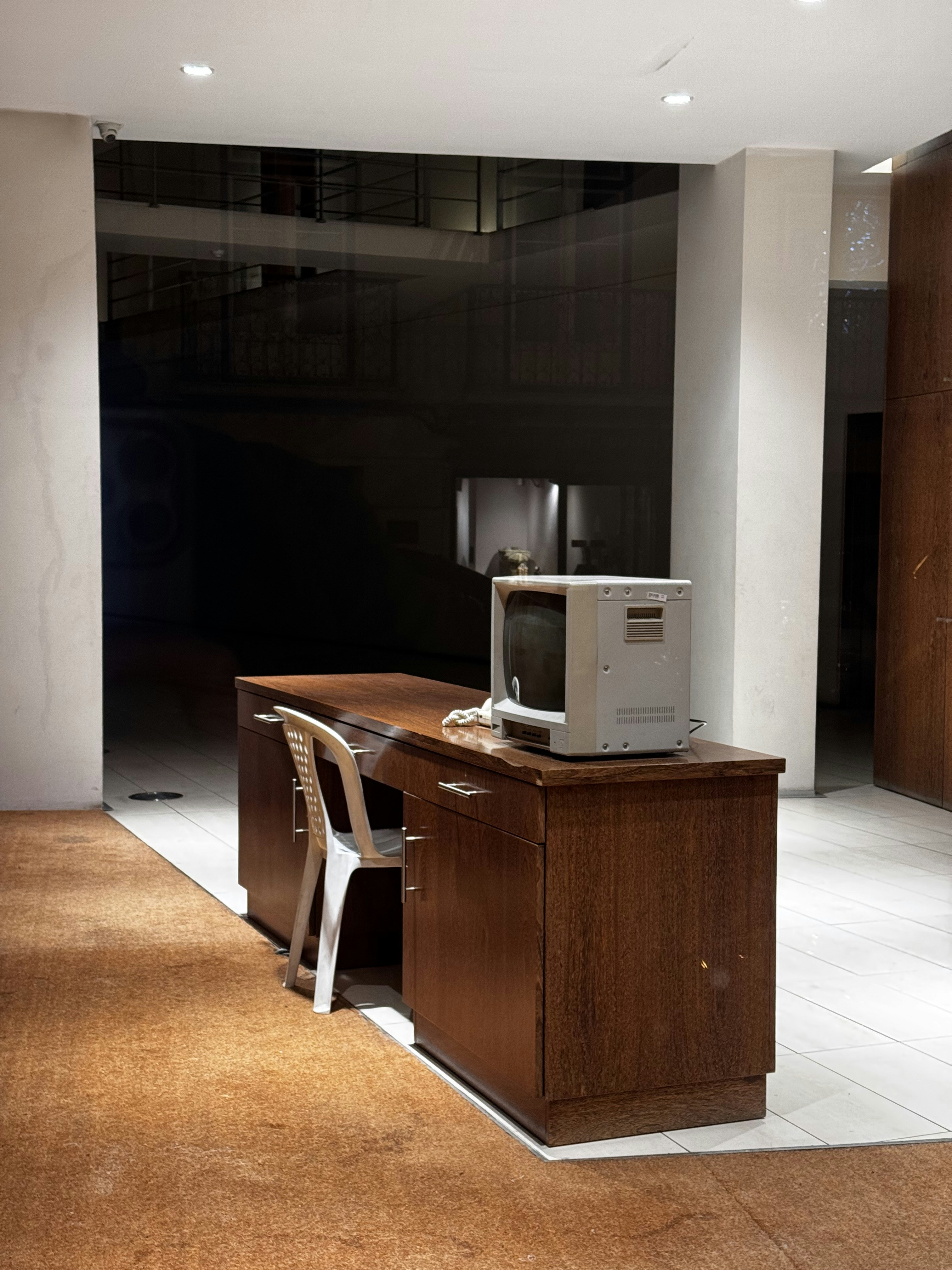 Wooden desk with old computer and chair.