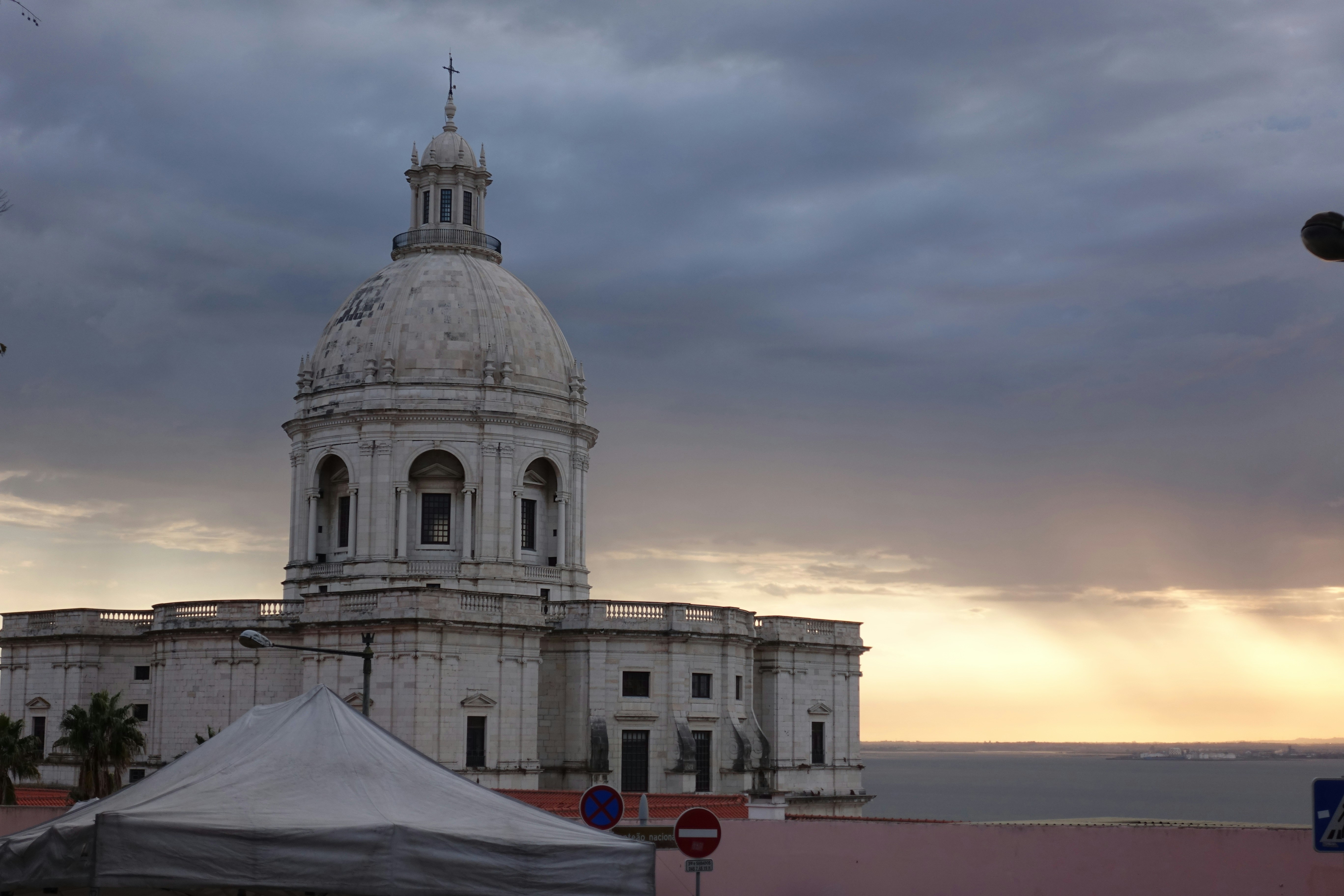 White domed building on the waterfront at sunset