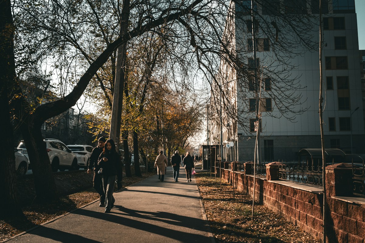 People walking on a sunny sidewalk, illustrating community engagement for virtual Giving Tuesday service ideas.