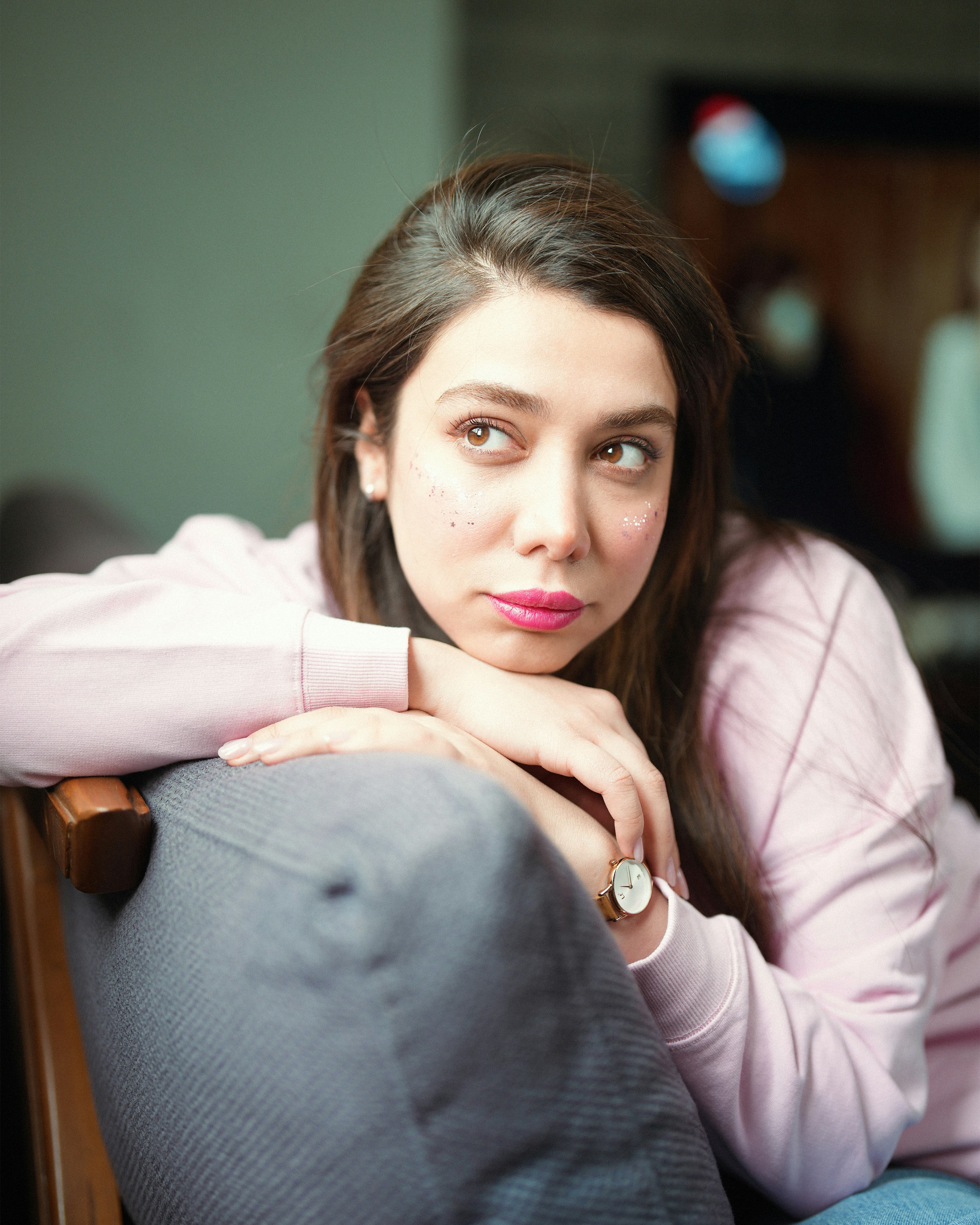 Young woman resting her chin on her arms.