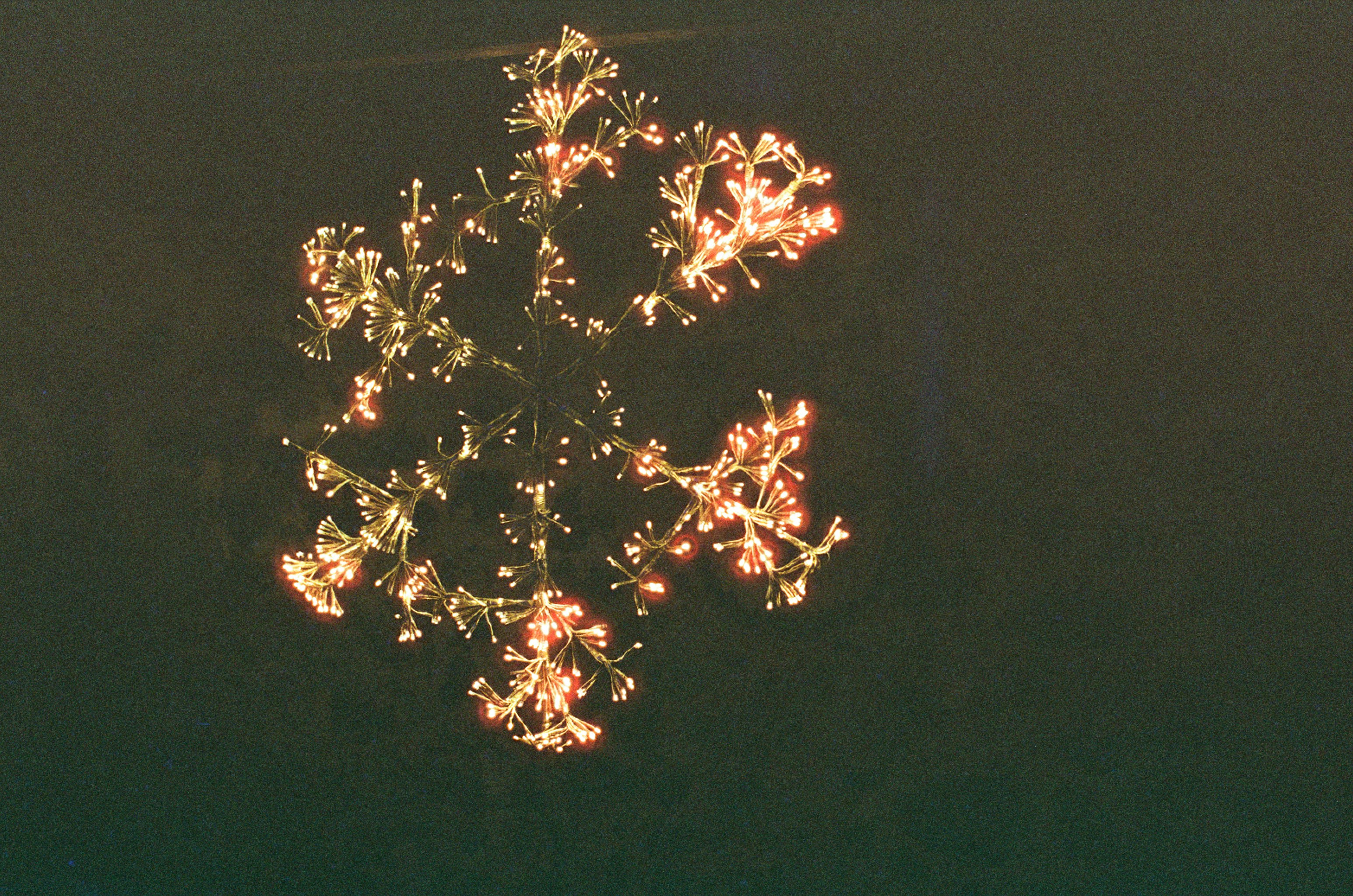 Decorative snowflake lights glowing in the dark.