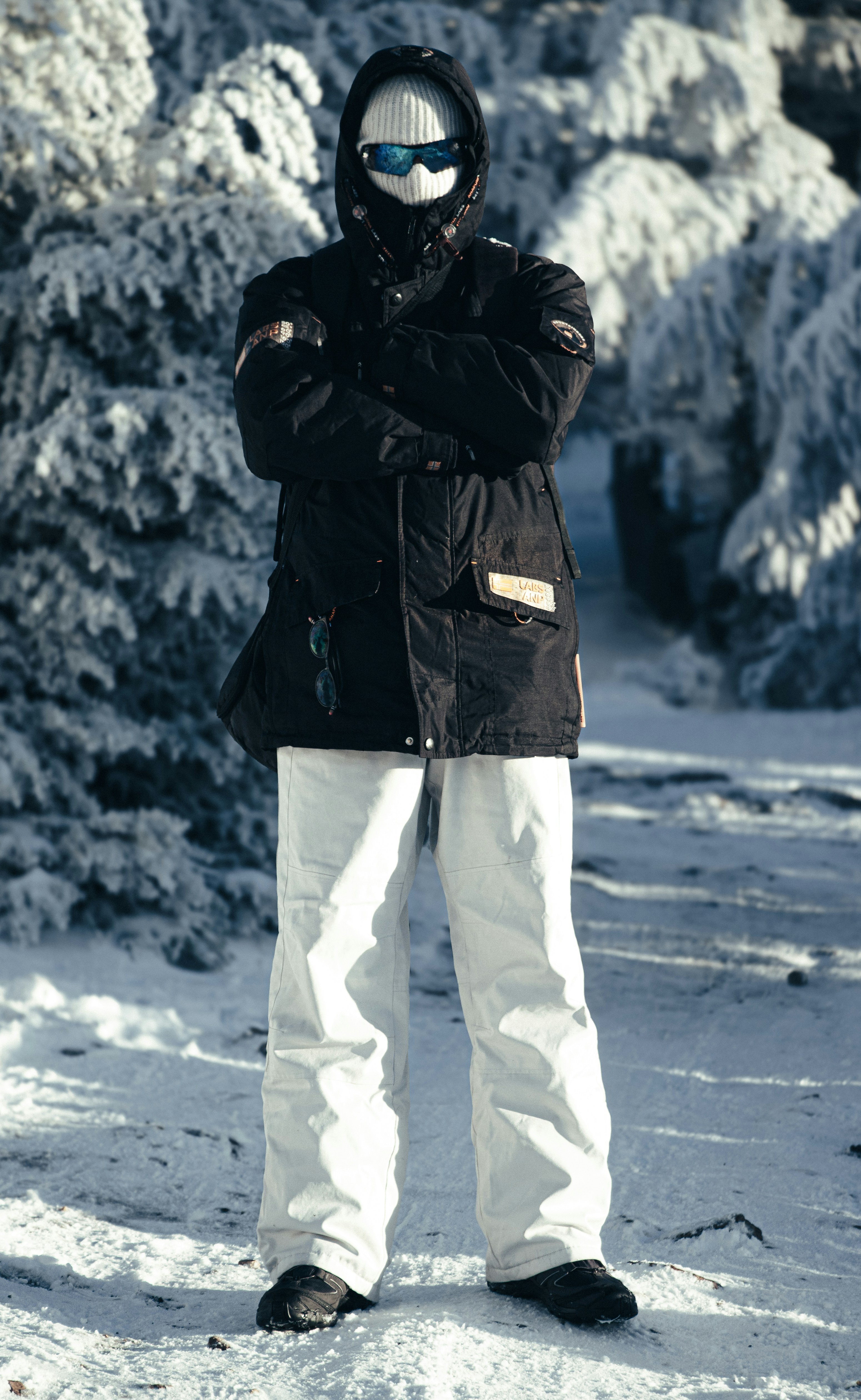 Person in winter clothing standing in snowy forest