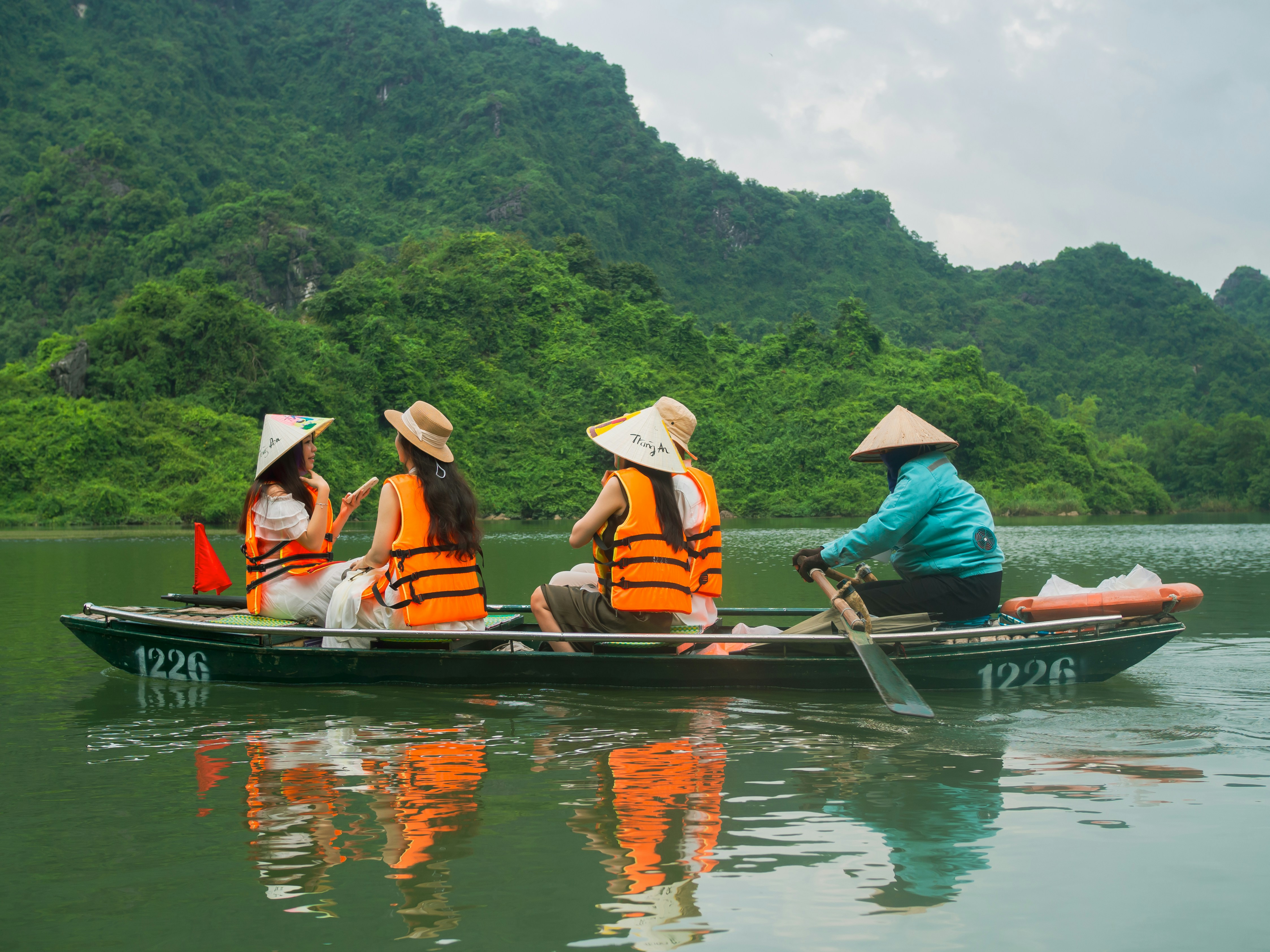 People on a boat tour with mountains in background