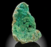 A vibrant green geode specimen with crystalline interior