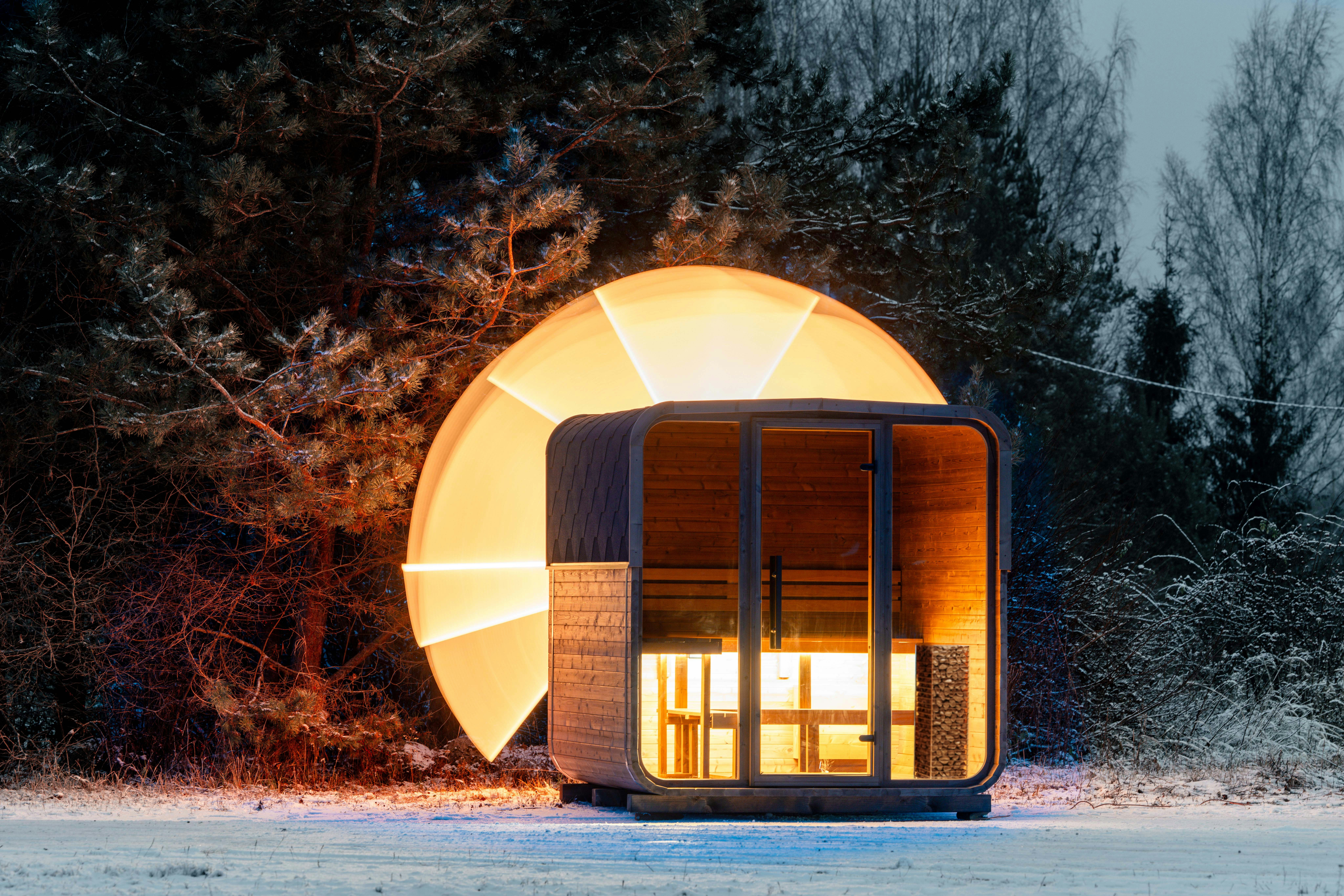 Modern sauna pod illuminated by warm light at dusk