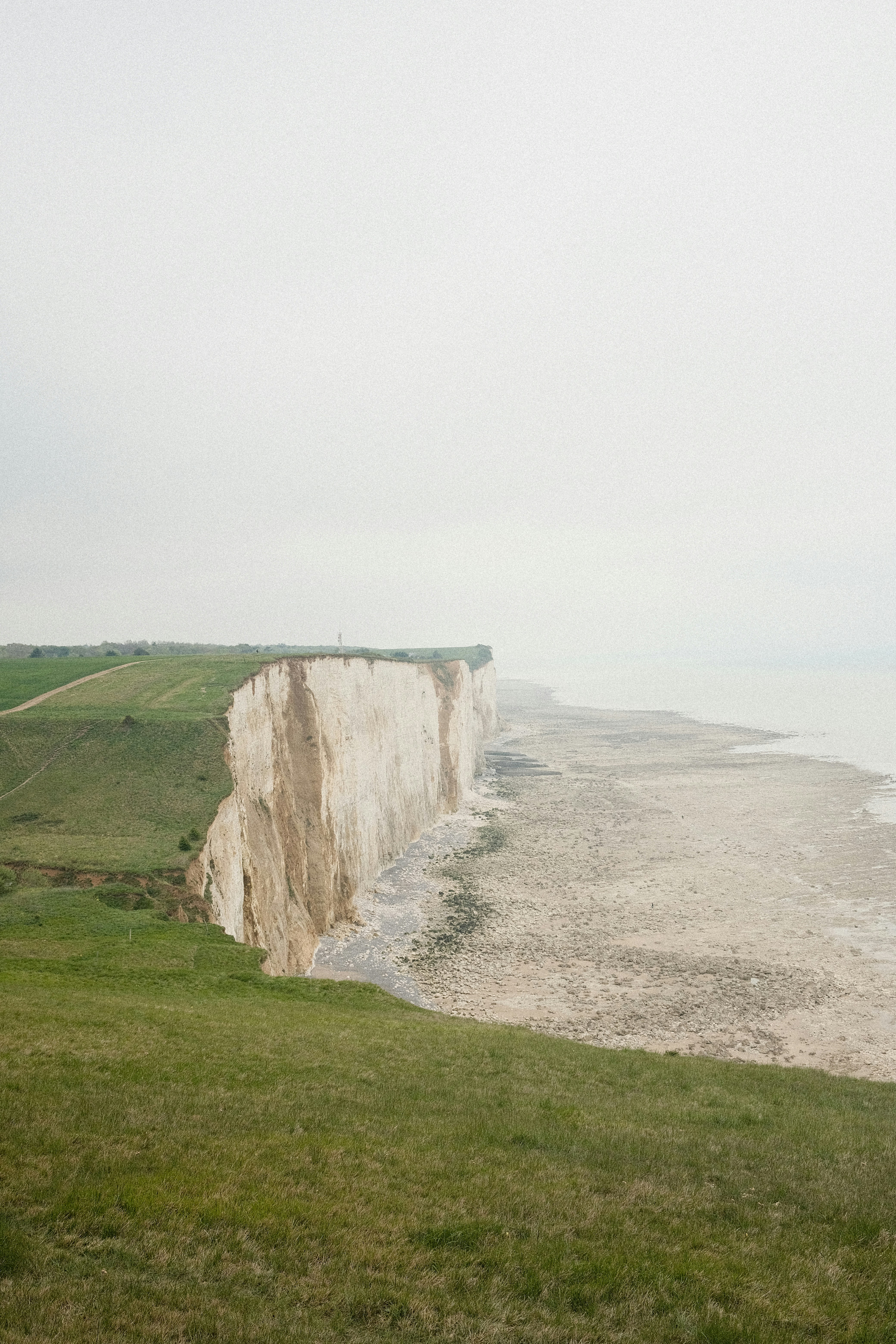White chalk cliffs overlooking a calm sea
