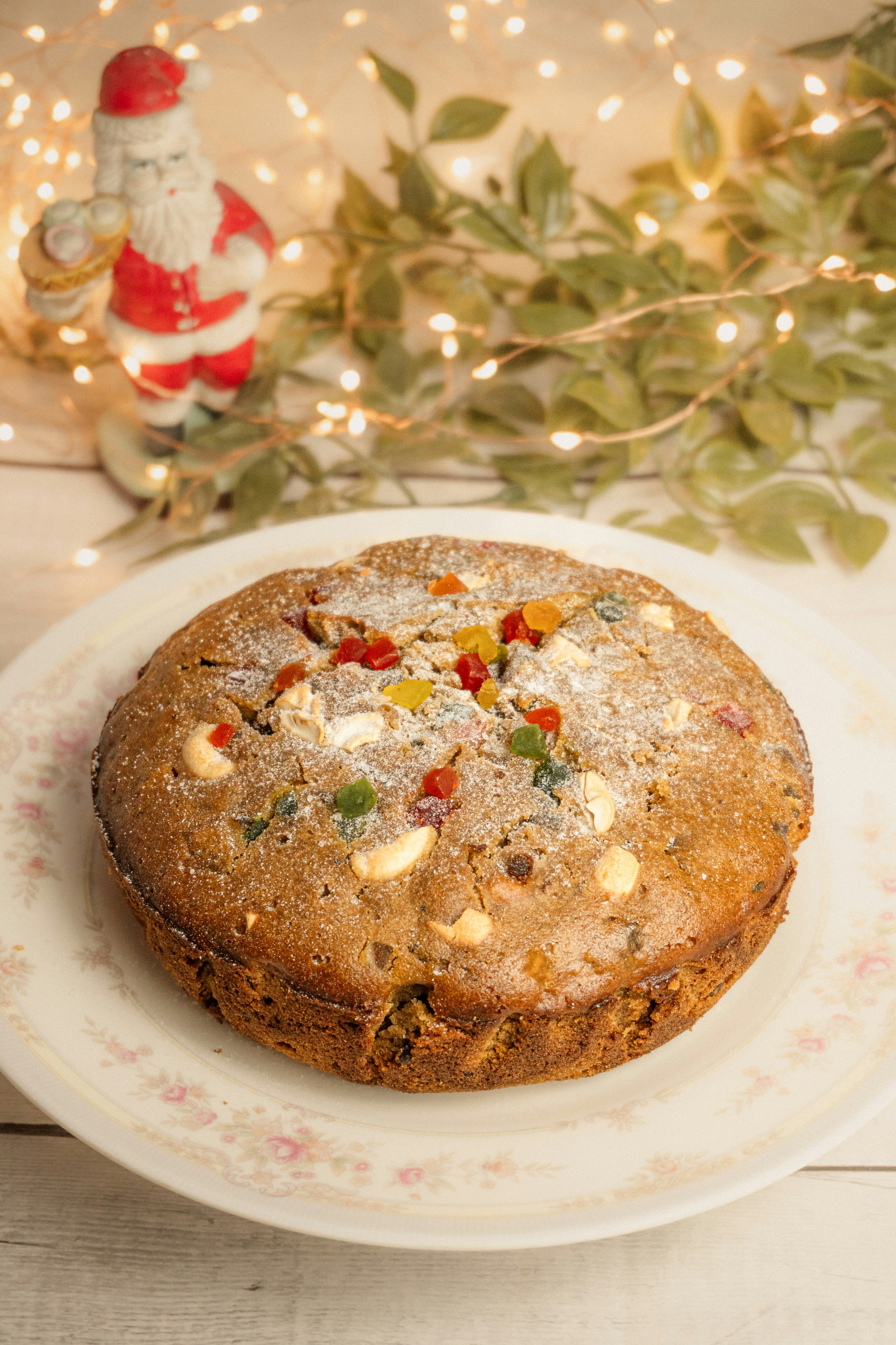 Christmas fruitcake with santa and lights