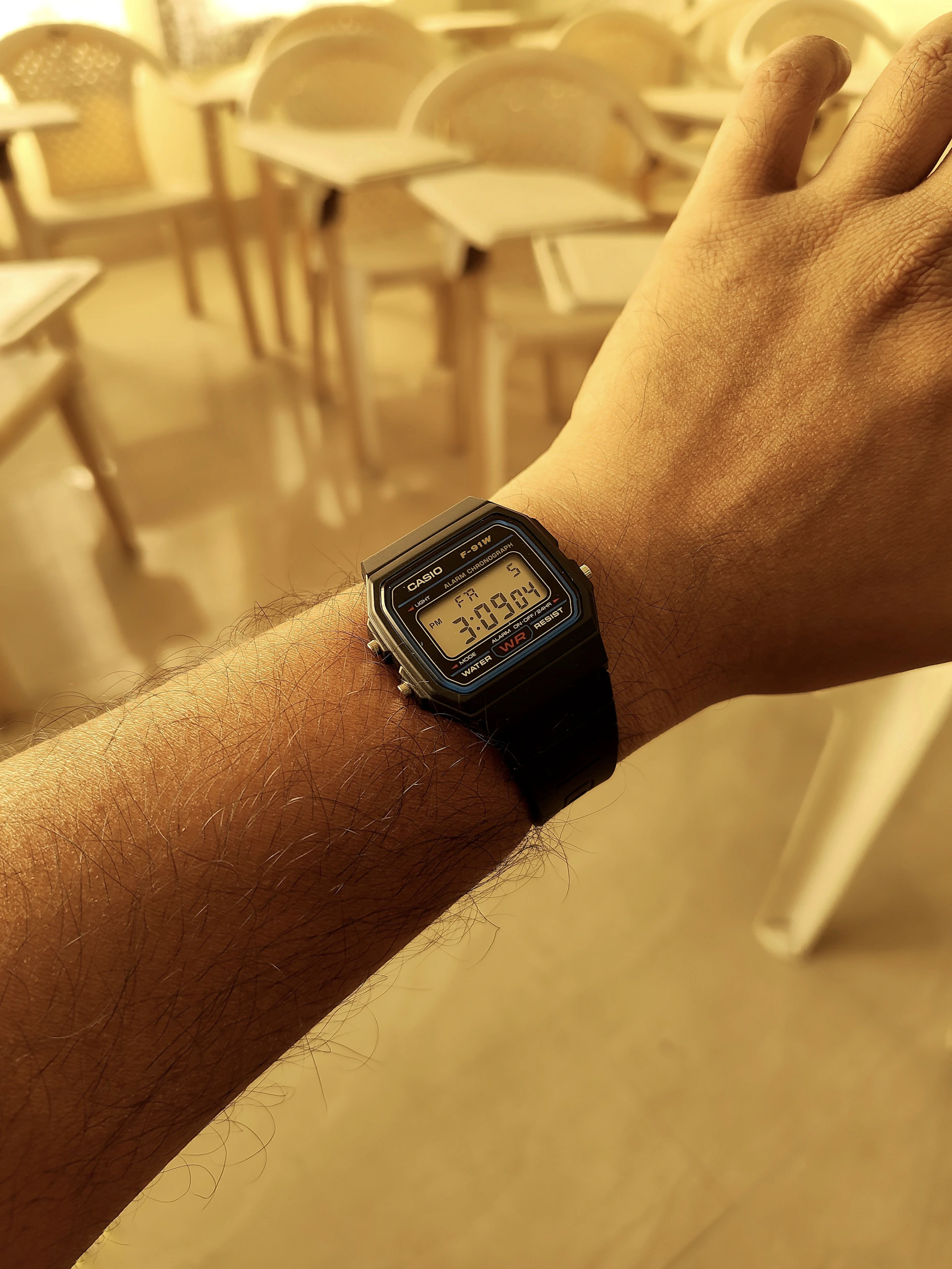 Person wearing a digital watch on arm