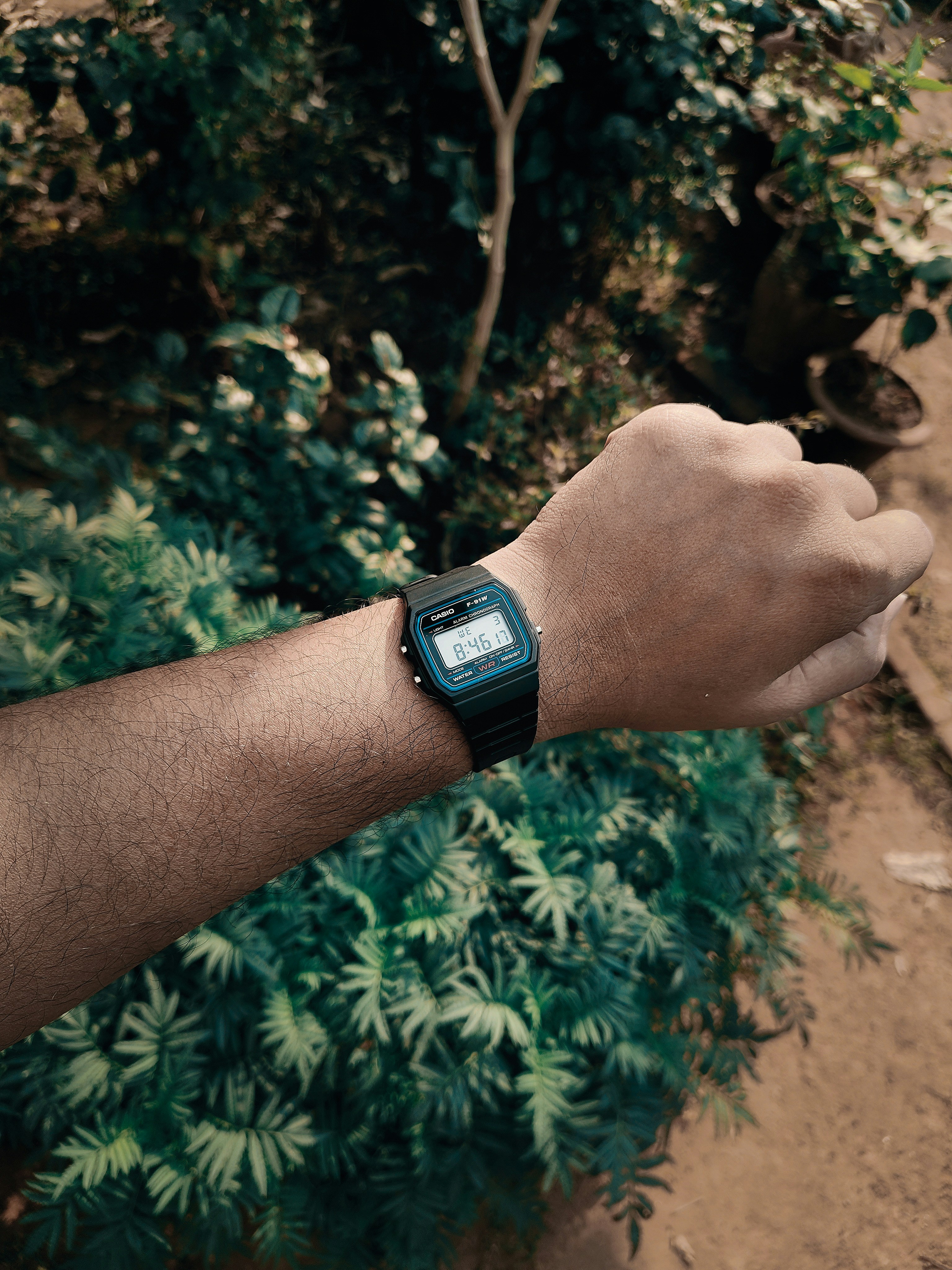 A person wearing a digital watch on their wrist.