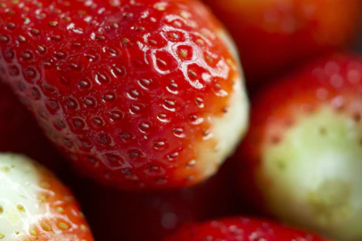 Close-up of ripe red strawberries with green stems.