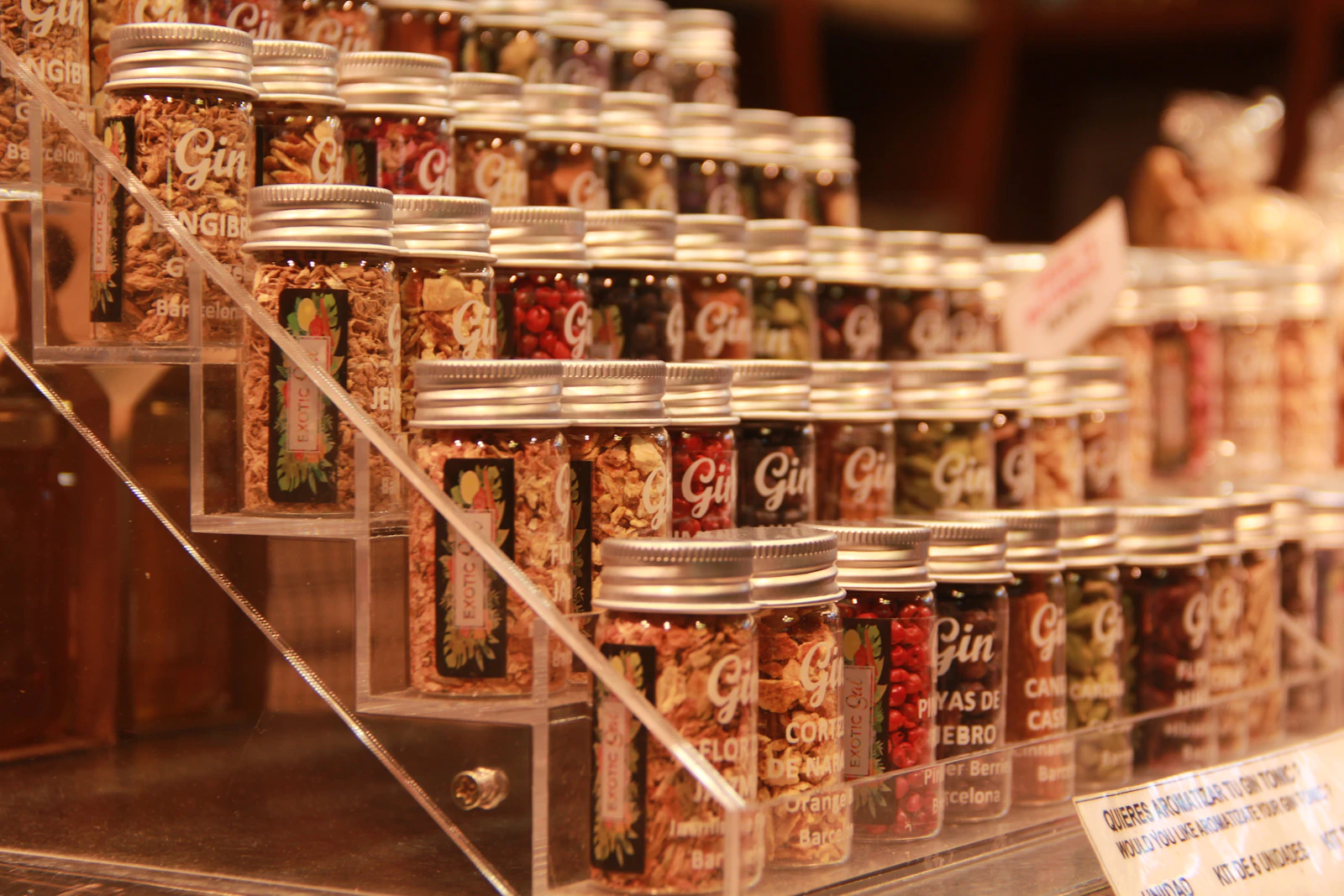 Rows of glass jars filled with Indian spices and botanicals