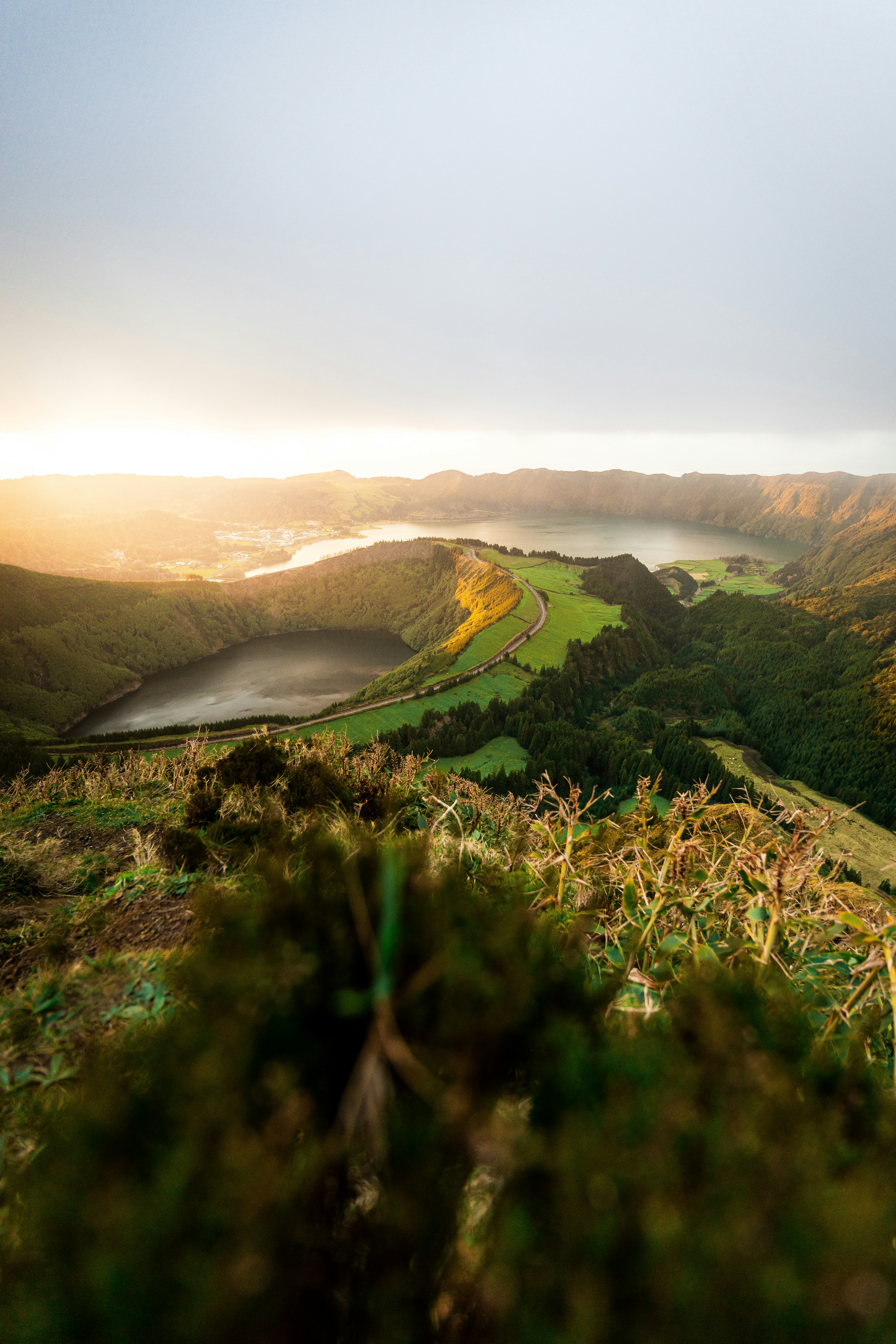 Sunrise over a lush green valley with lakes