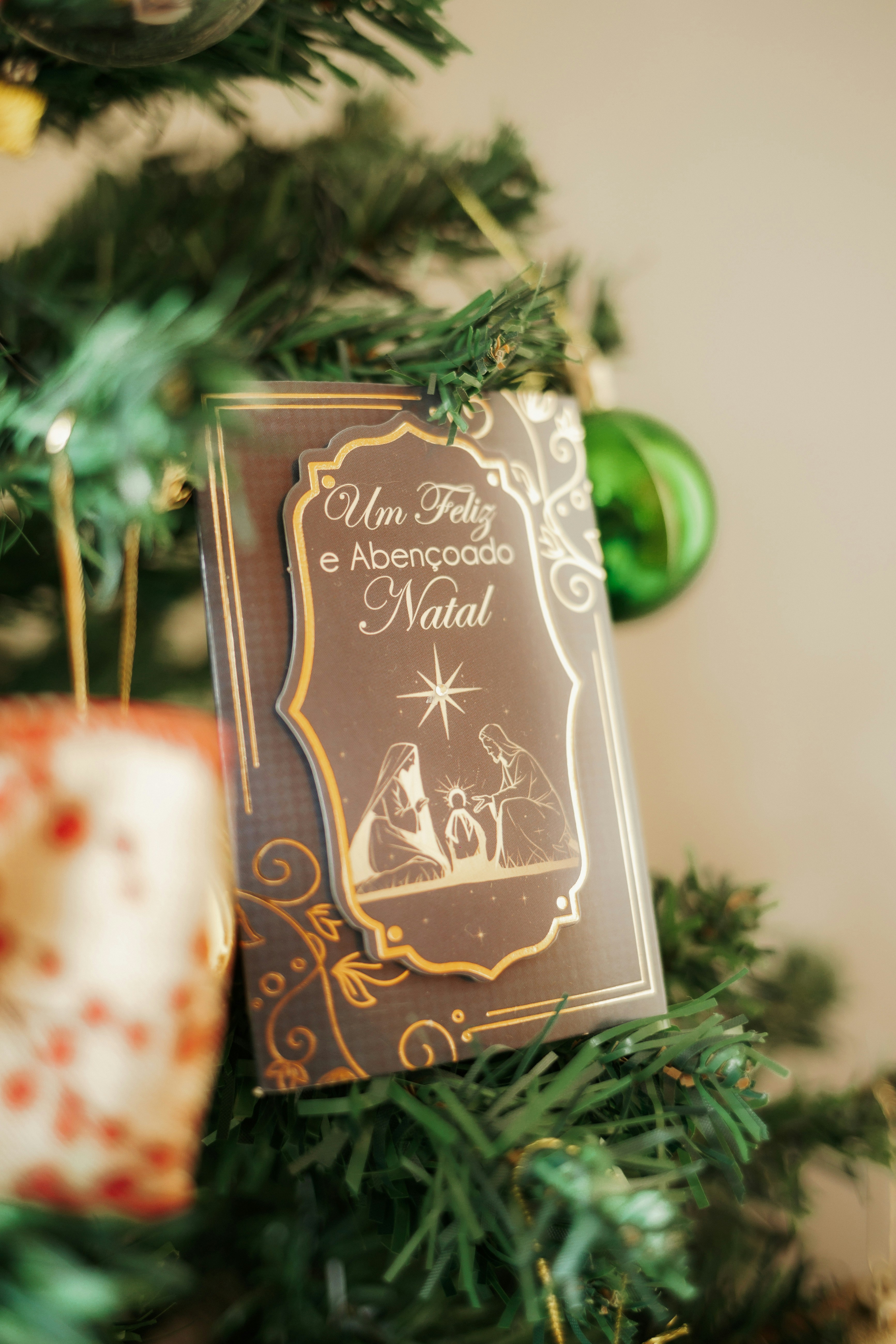 Christmas card with nativity scene on tree.