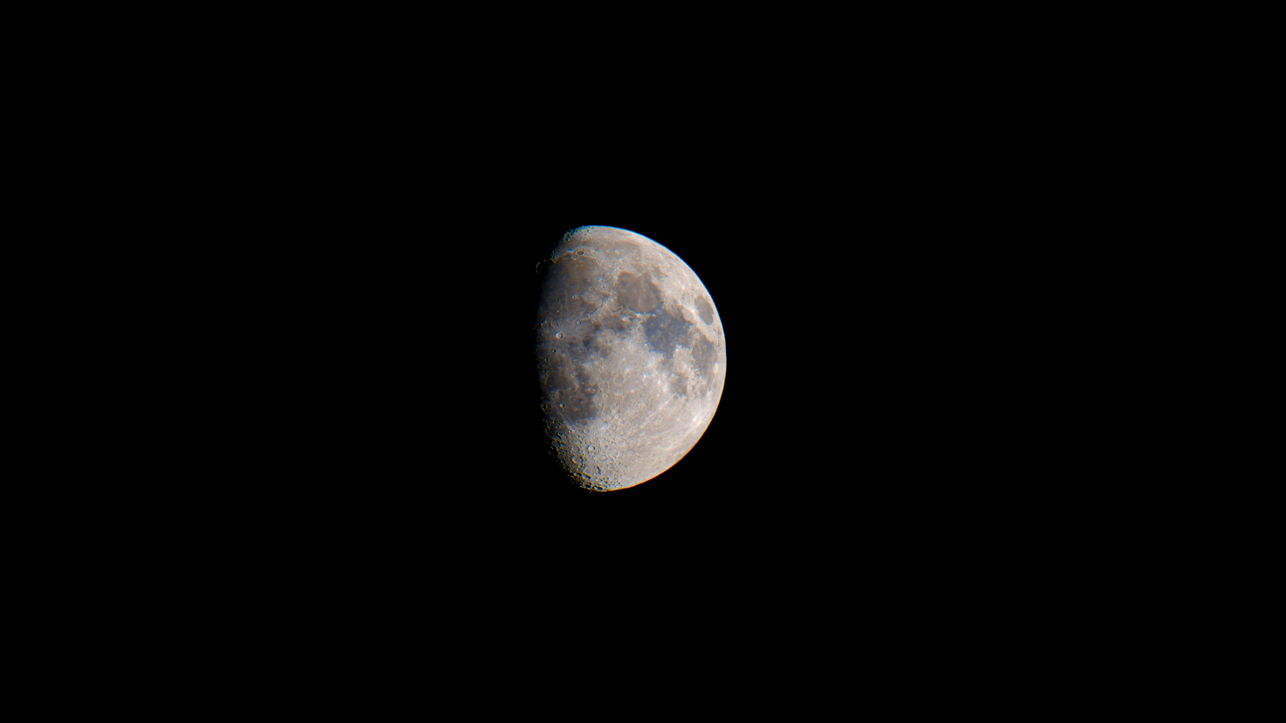 Half moon in the dark night sky
