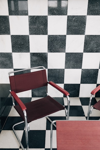 Two chairs in front of a checkered wall