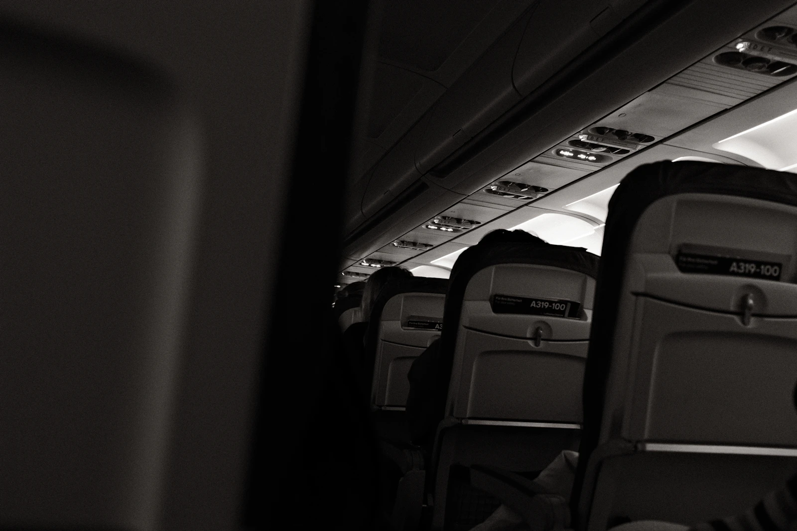 Passengers seated in an aircraft cabin during a flight