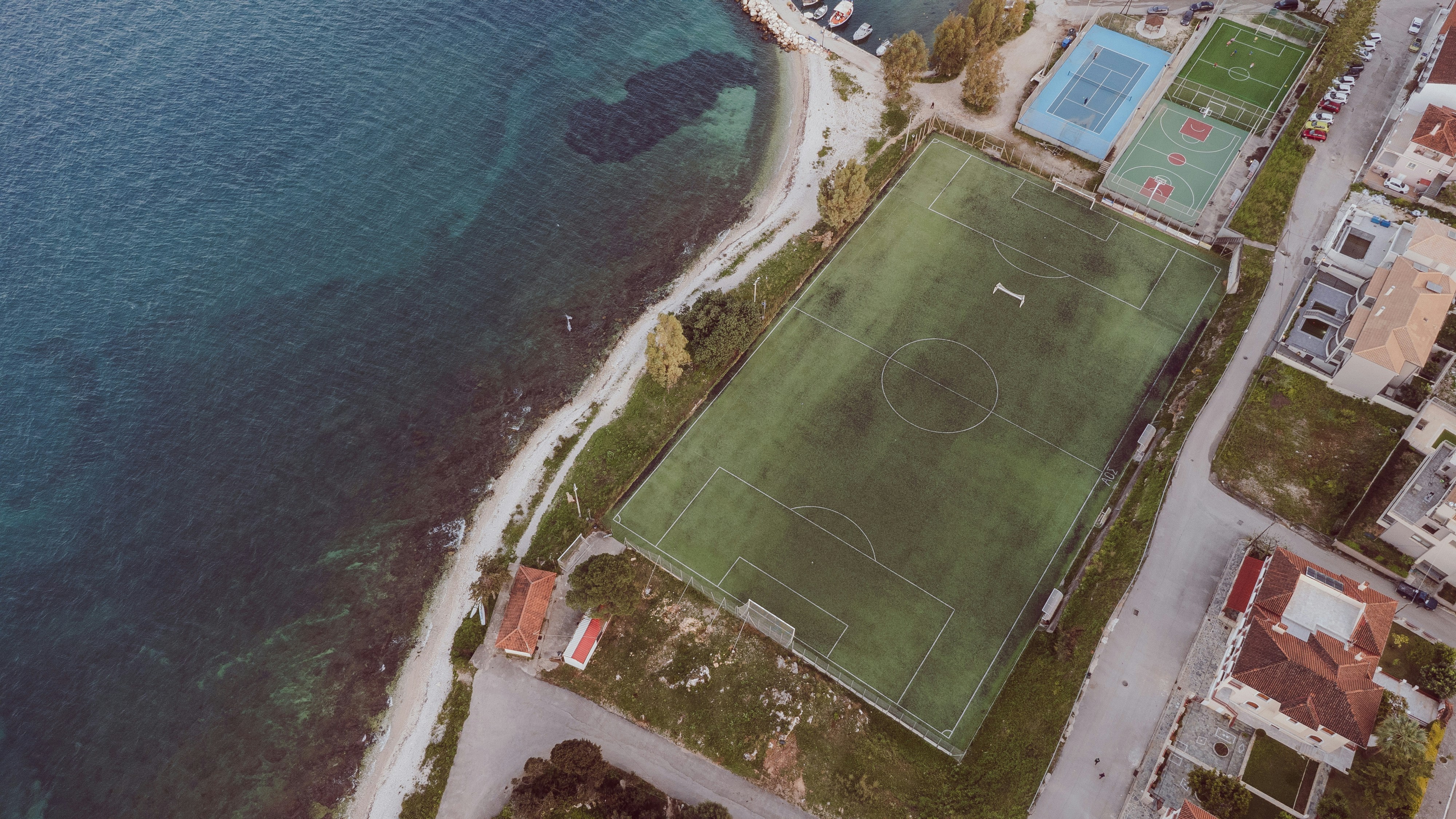 Aerial view of a soccer field by the ocean.