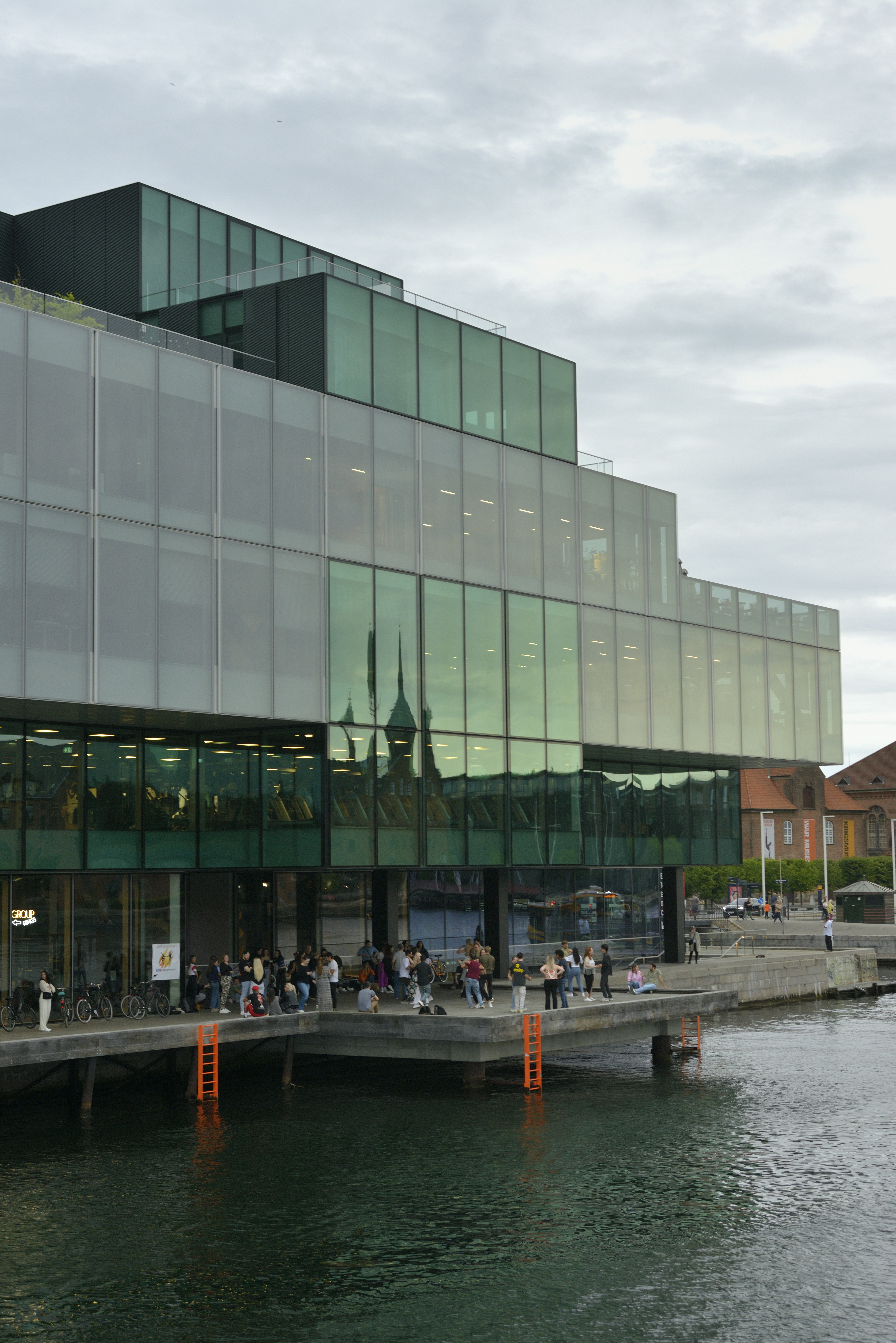 Modern building with glass facade overlooking water