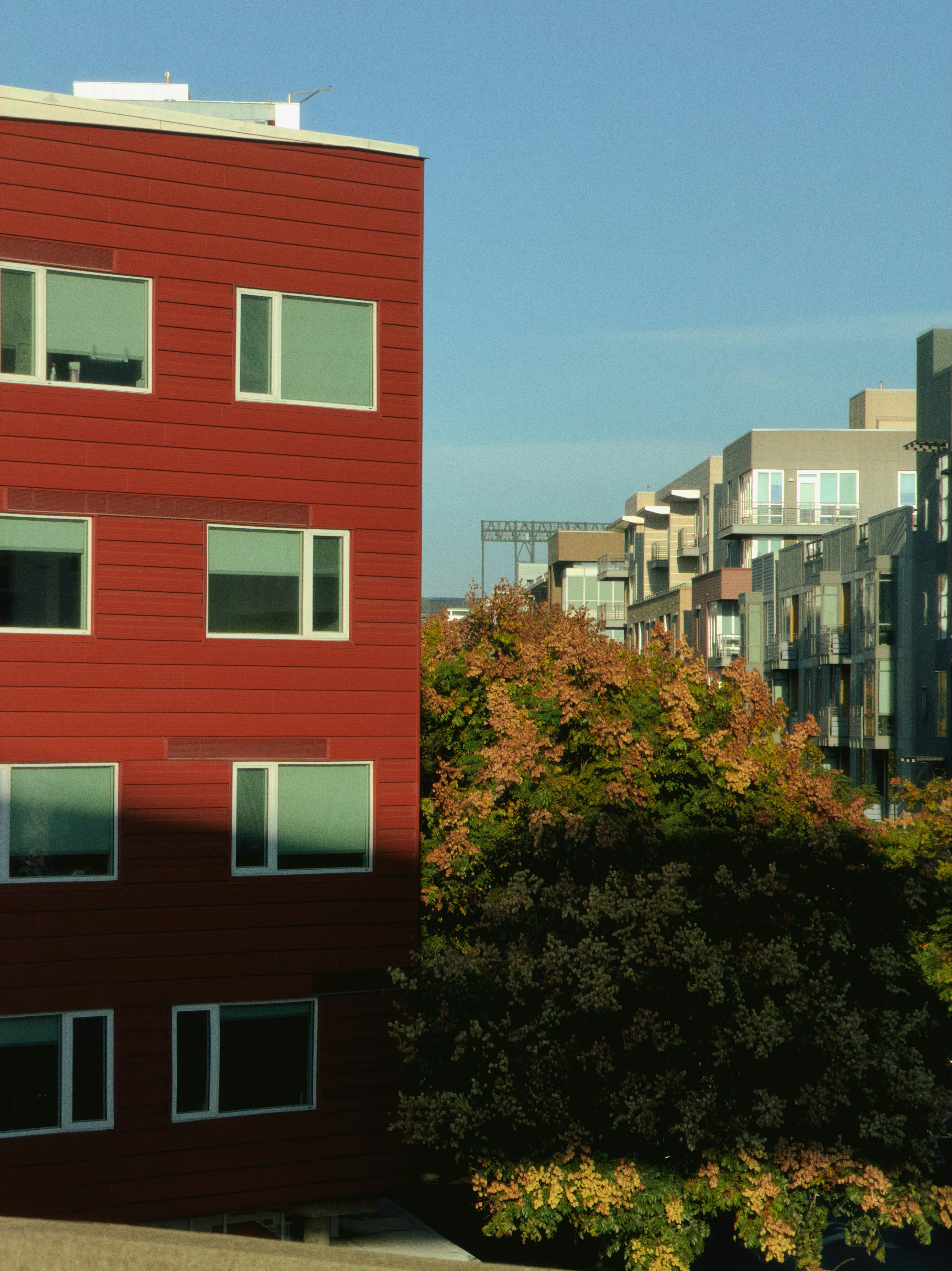 Modern red building next to apartment complex