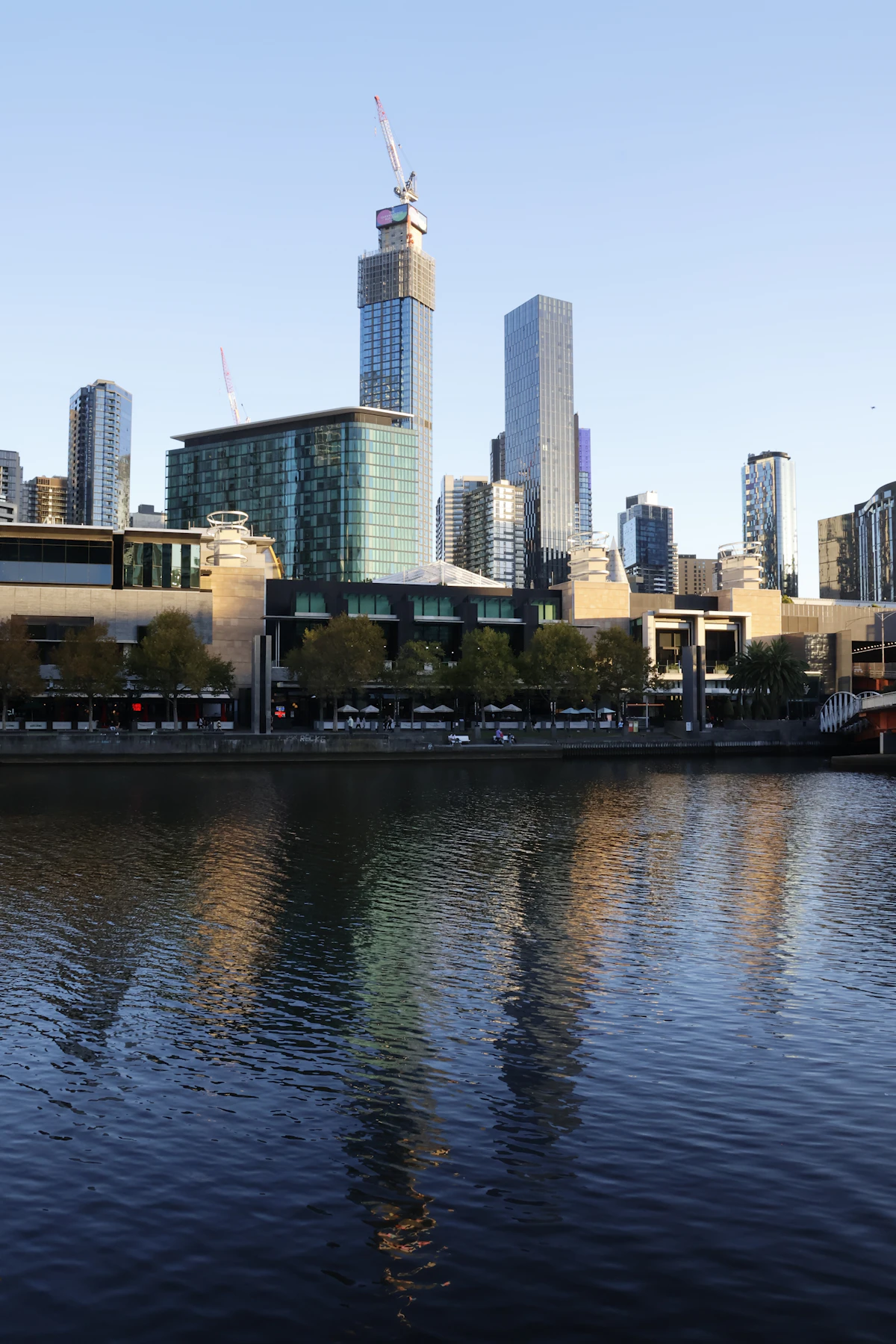 Melbourne skyline reflected across the Yarra River at sunrise
