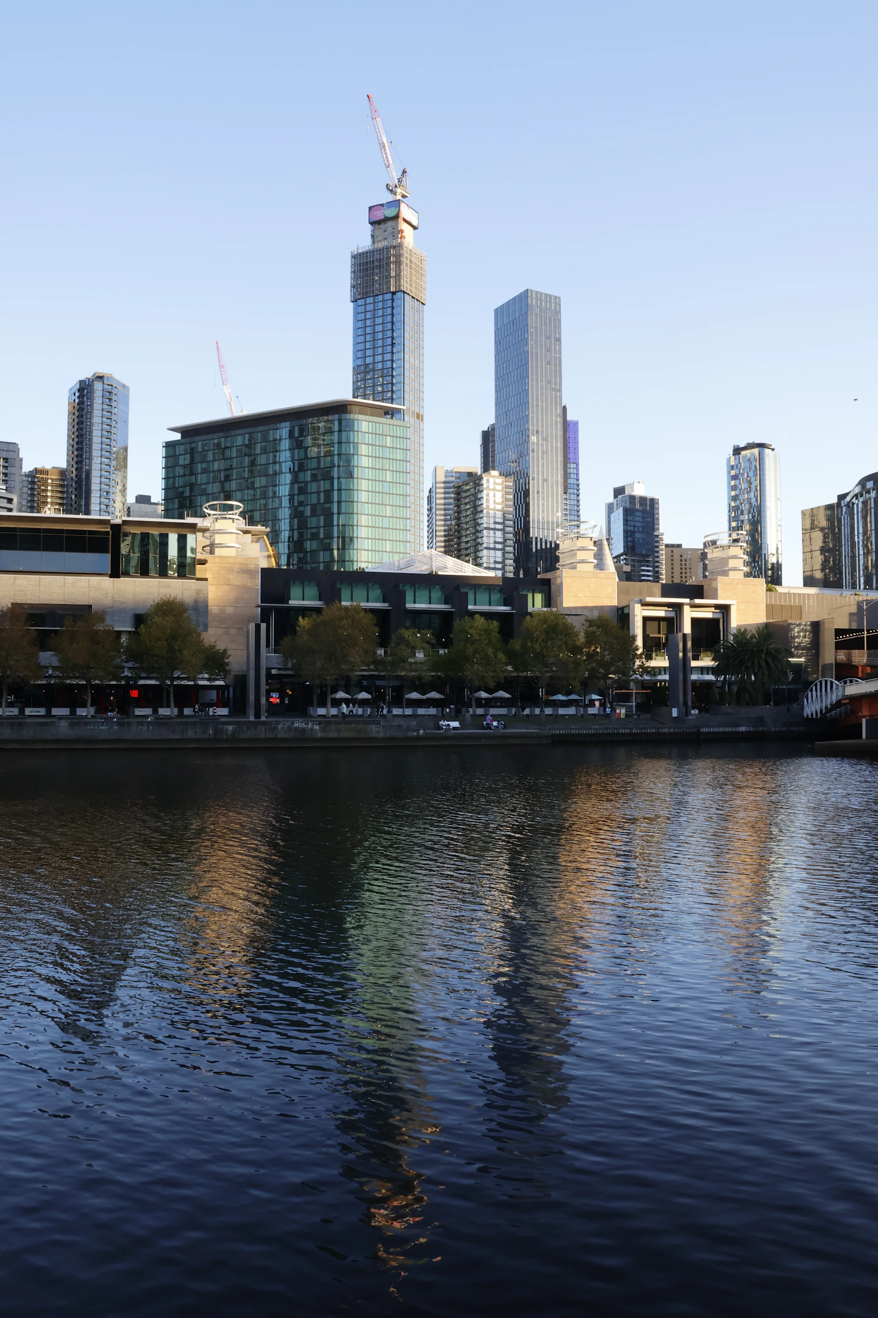 Melbourne skyline reflected across the Yarra River at sunrise