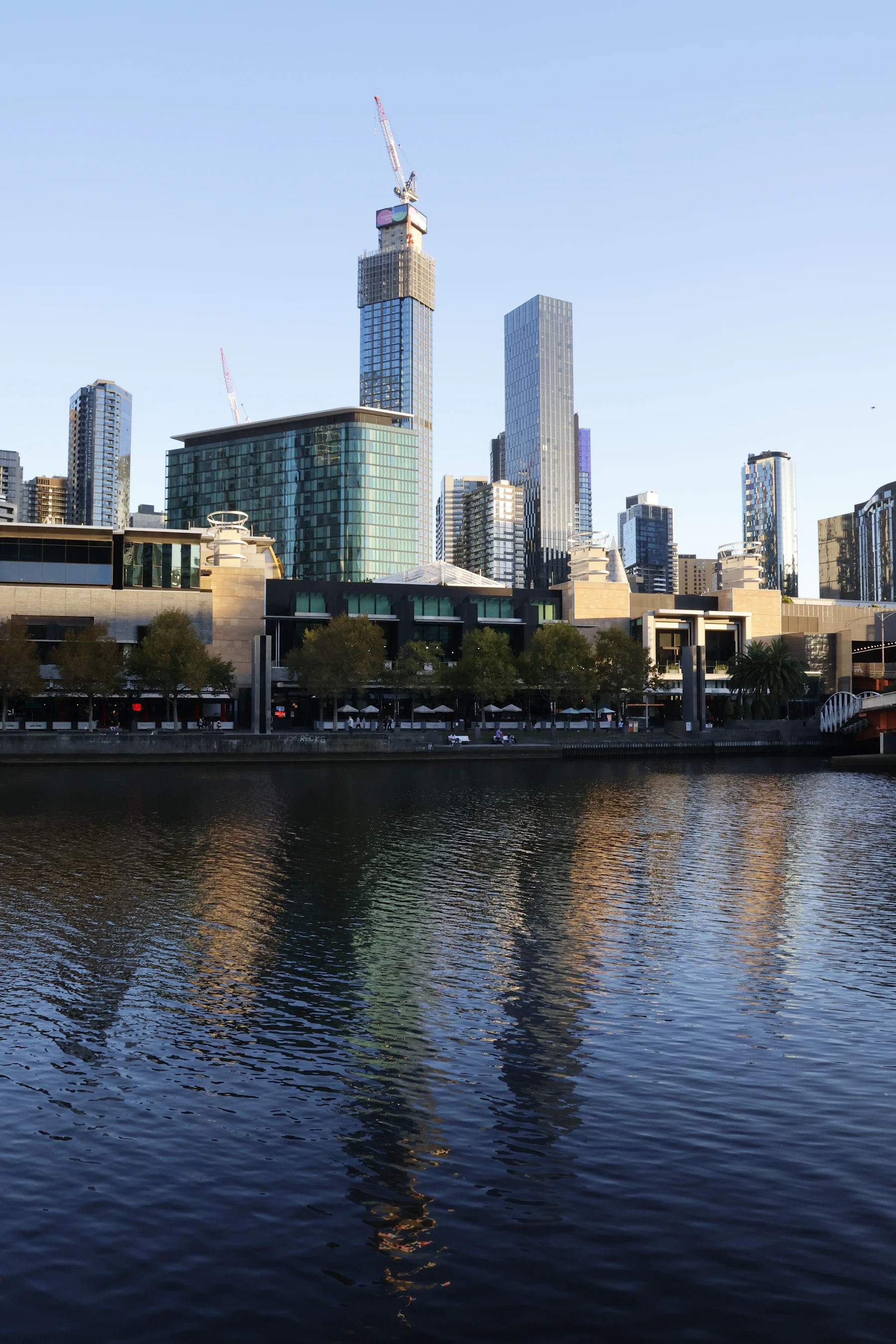 Melbourne skyline reflected across the Yarra River at sunrise