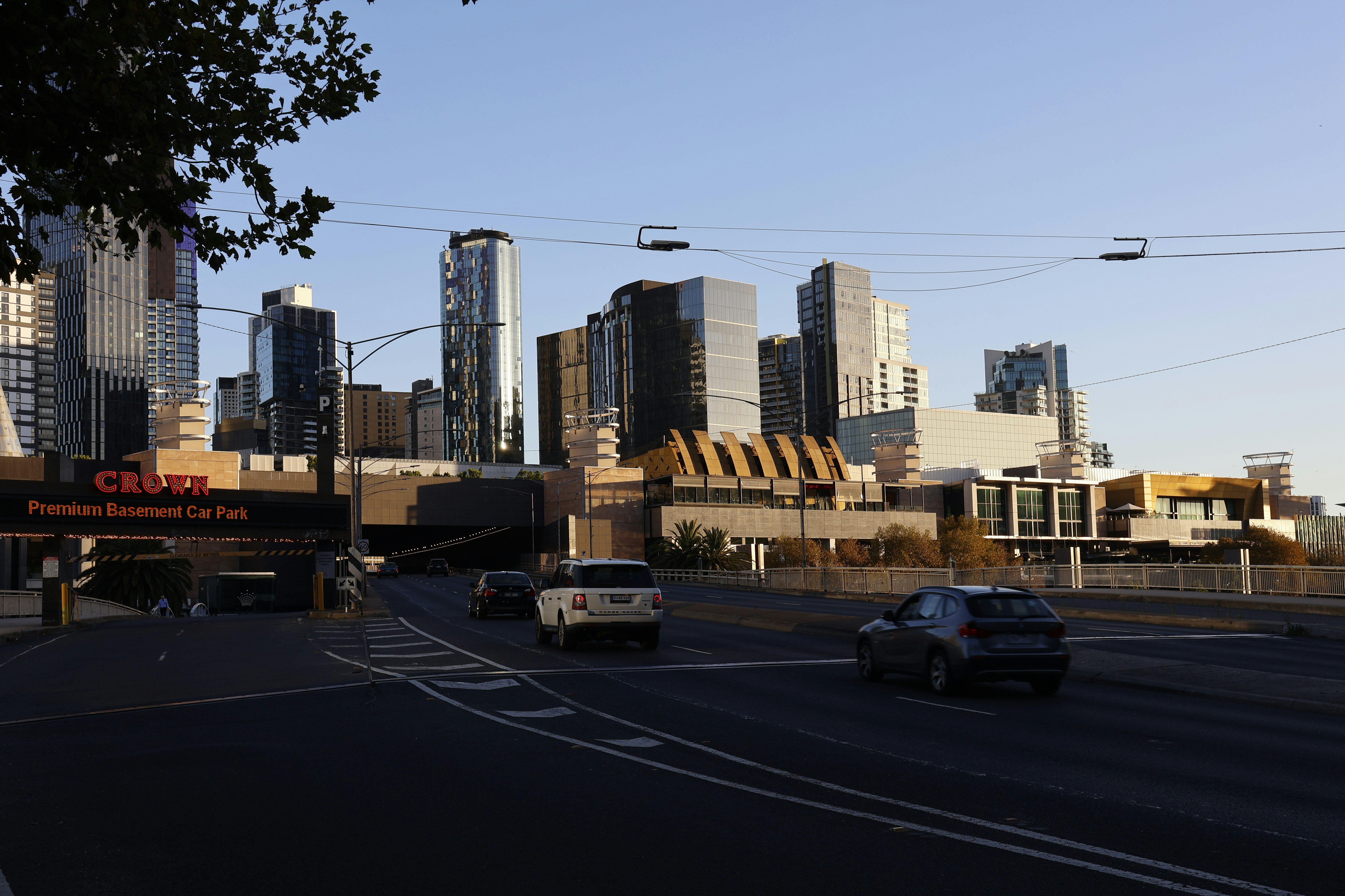 City skyline with modern buildings and cars on road.
