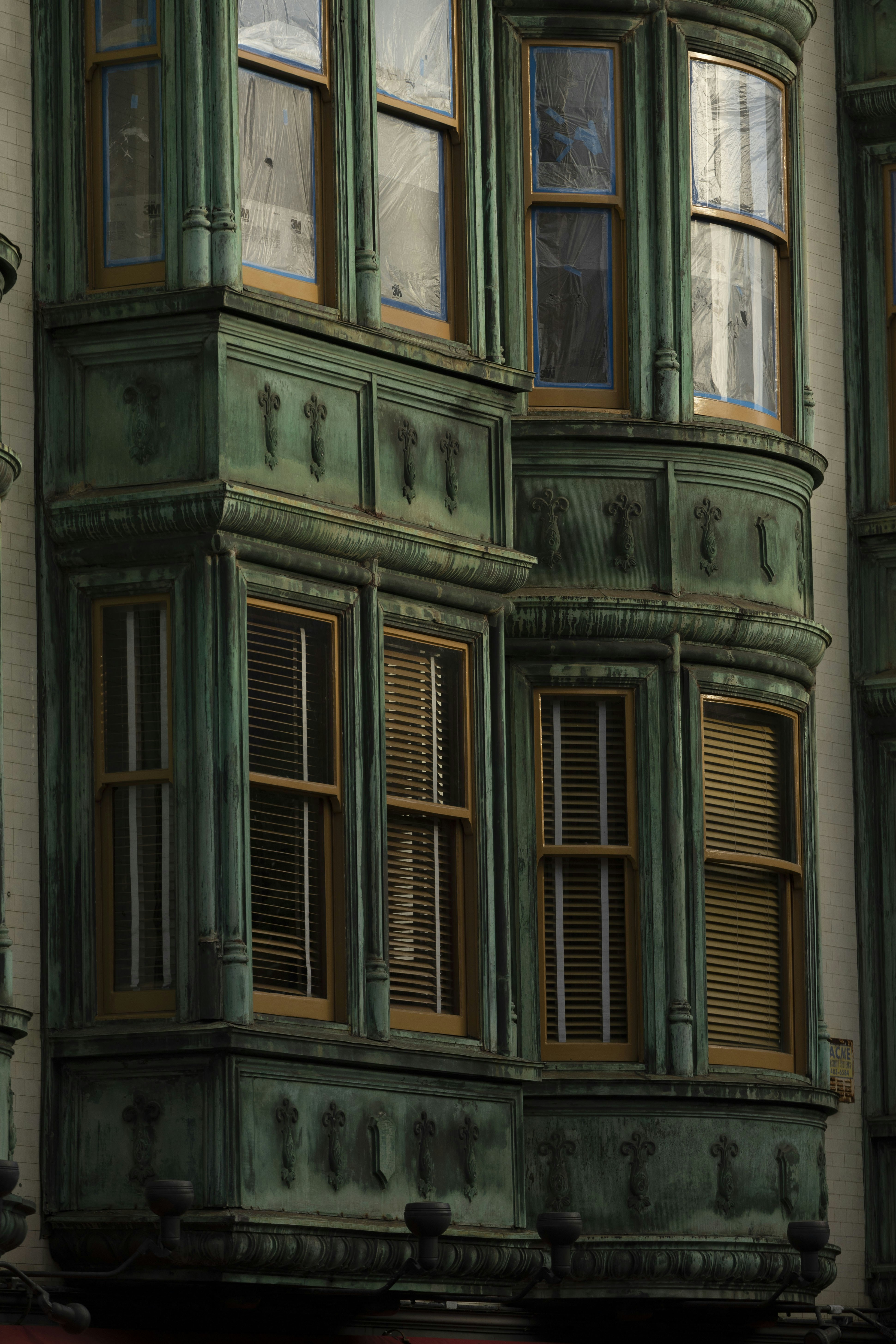 Ornate green bay windows on a building