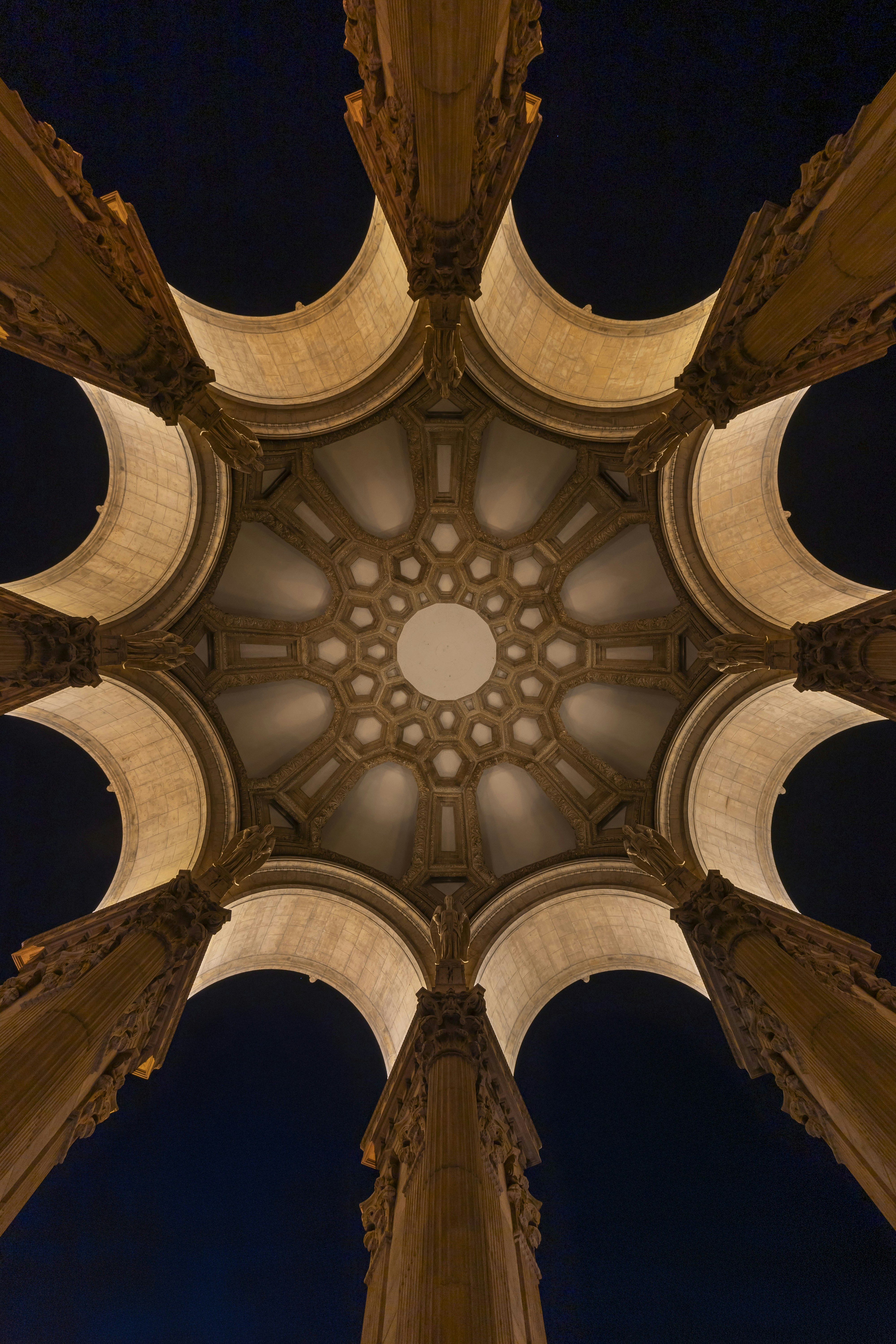 Looking up at a grand domed ceiling with columns
