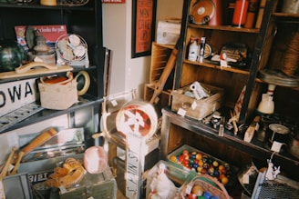 Collection of vintage items on shelves and floor.