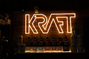Neon sign above bottles on a shelf
