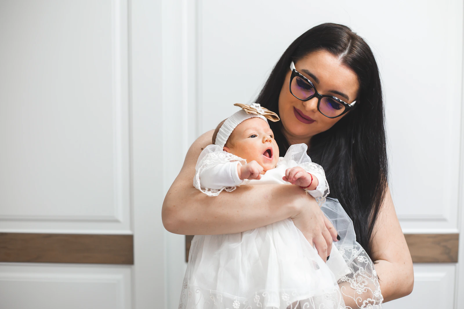 Mother gently holding a newborn child