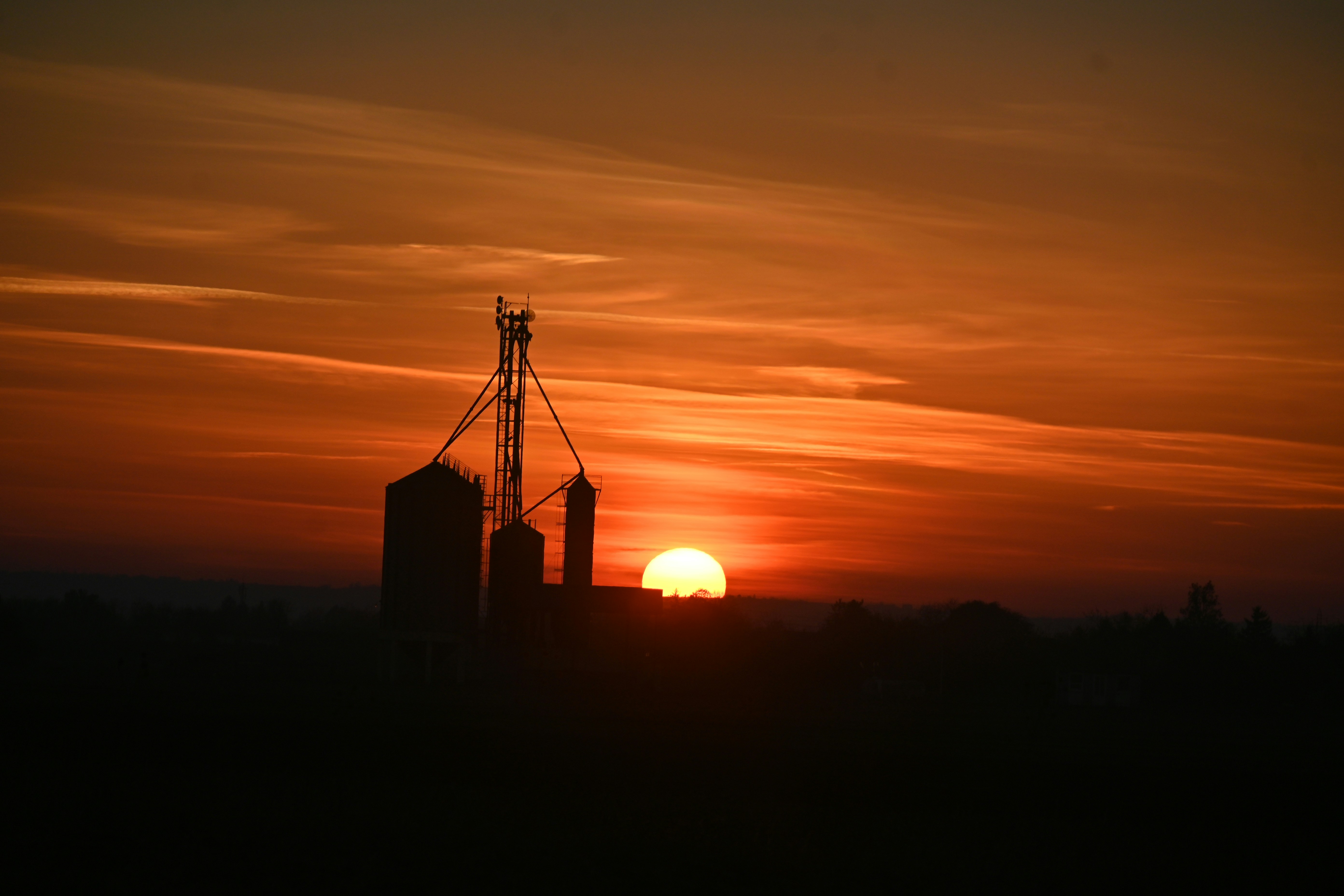 Sunset over silos on a farm at farm
