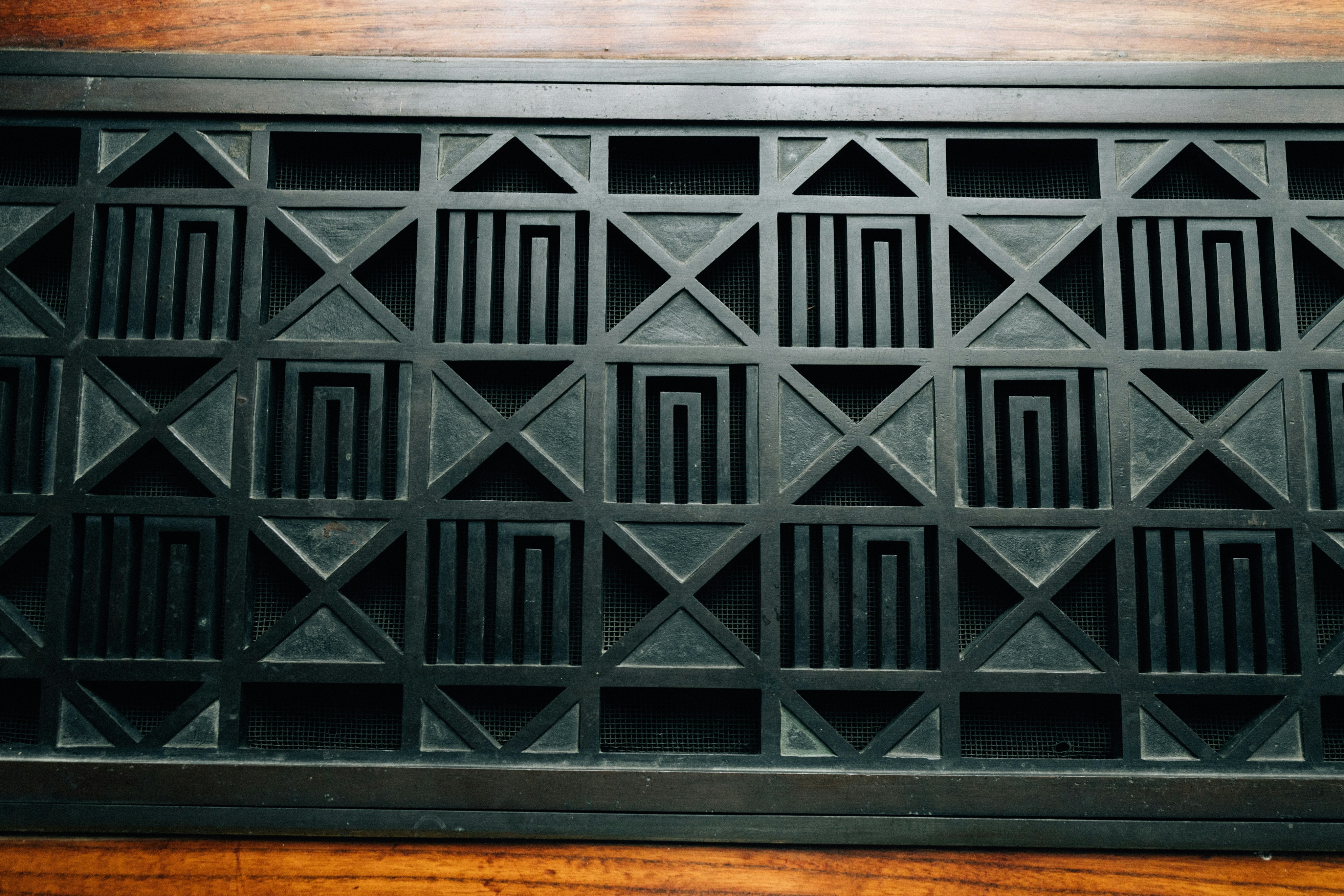 Black geometric pattern on a wooden surface