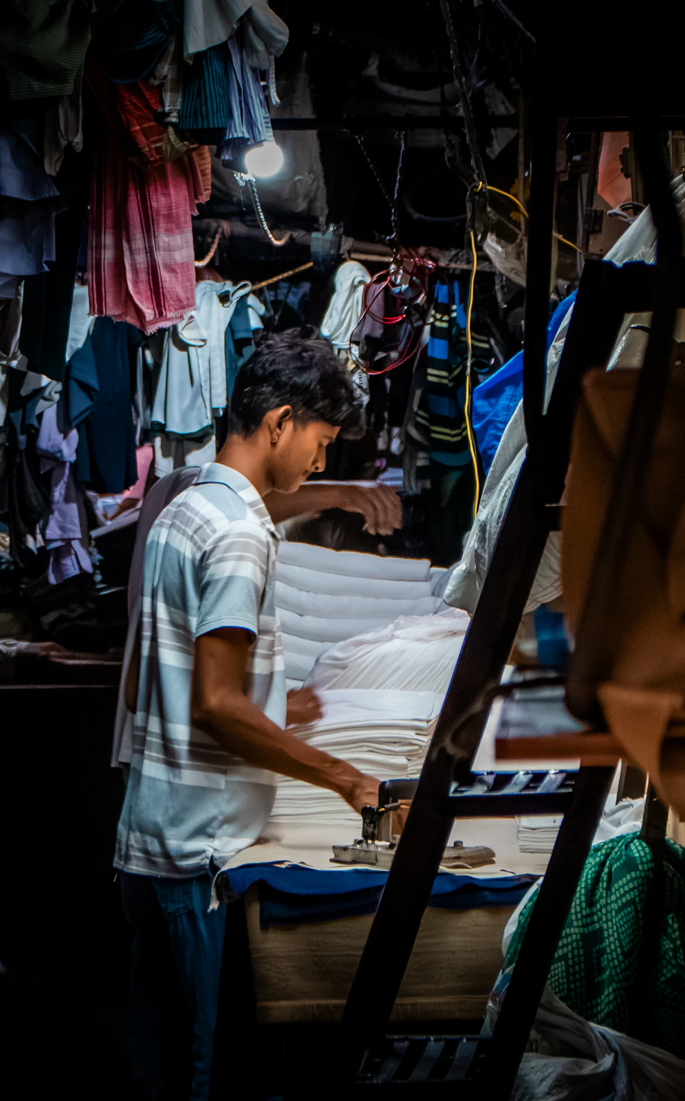 Laundry worker pressing freshly cleaned linens