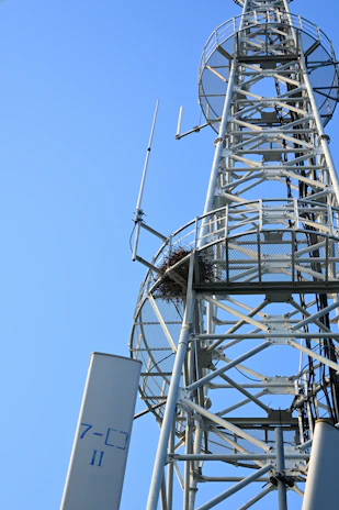 Tall metal tower with antennas against clear blue sky