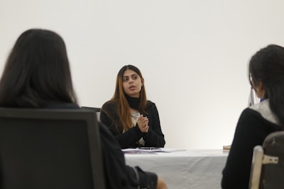 Woman speaking to two people across table